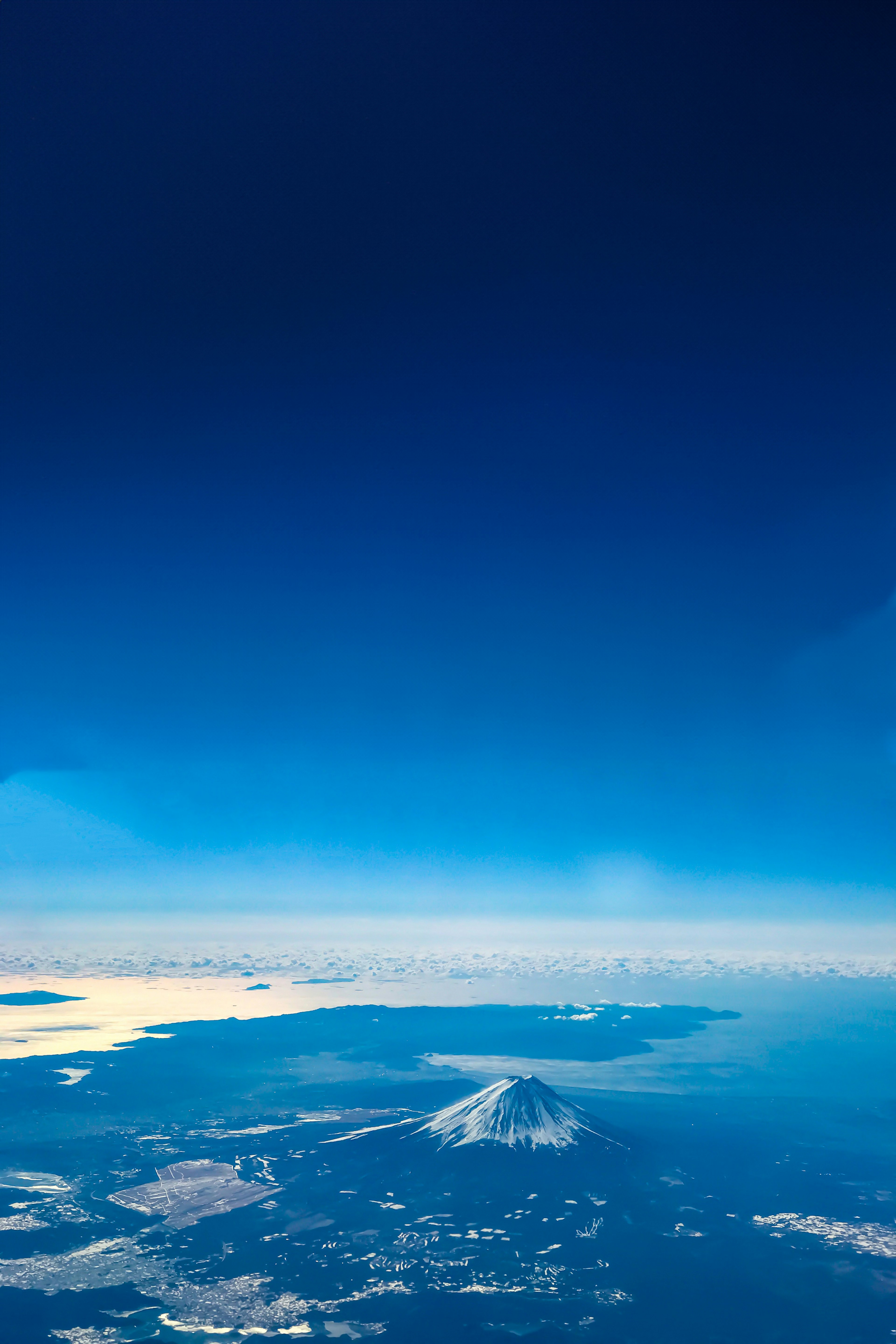 Aerial view of a volcano and the blue ocean