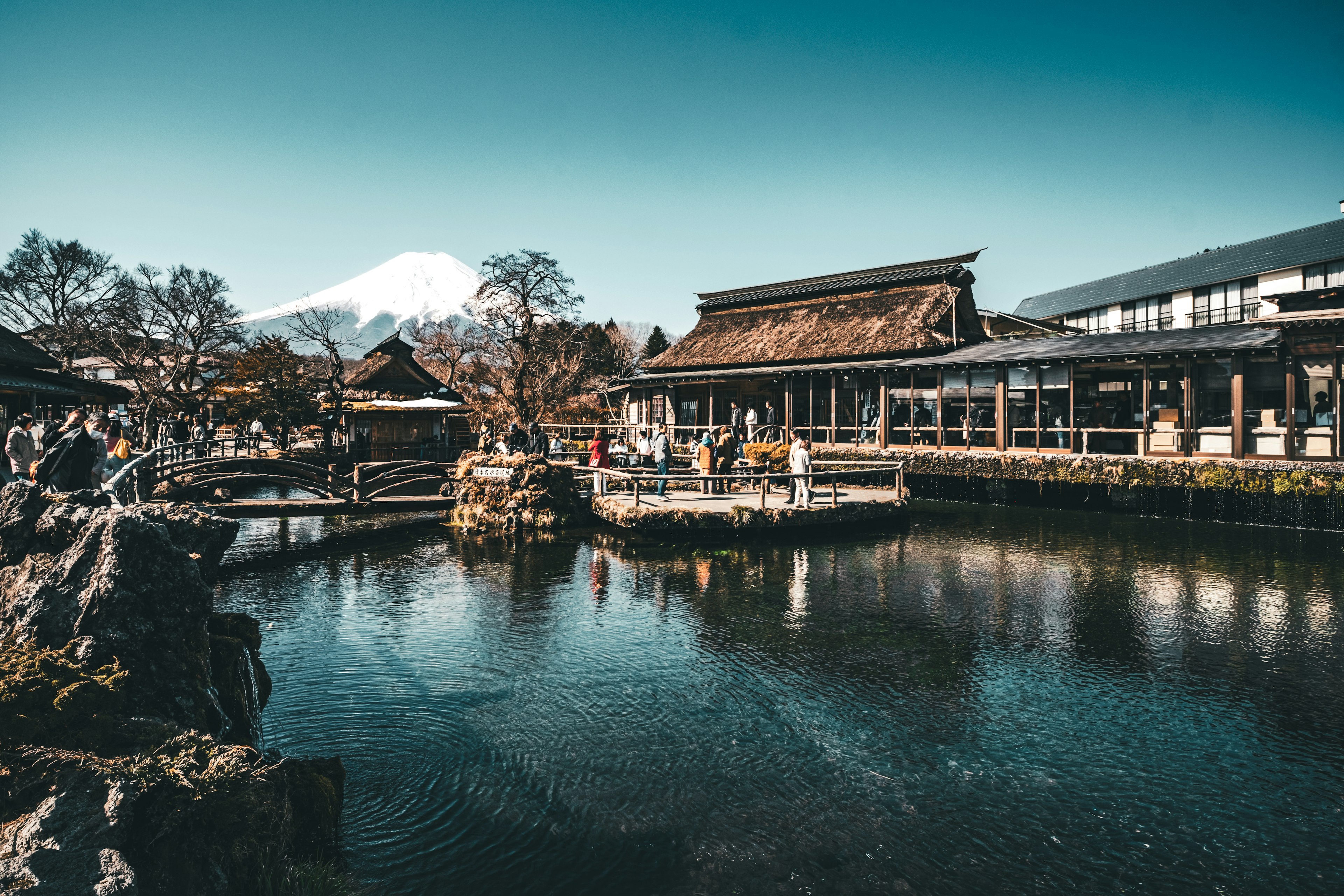 Scenic view of a hot spring town with Mount Fuji in the background reflecting on the water