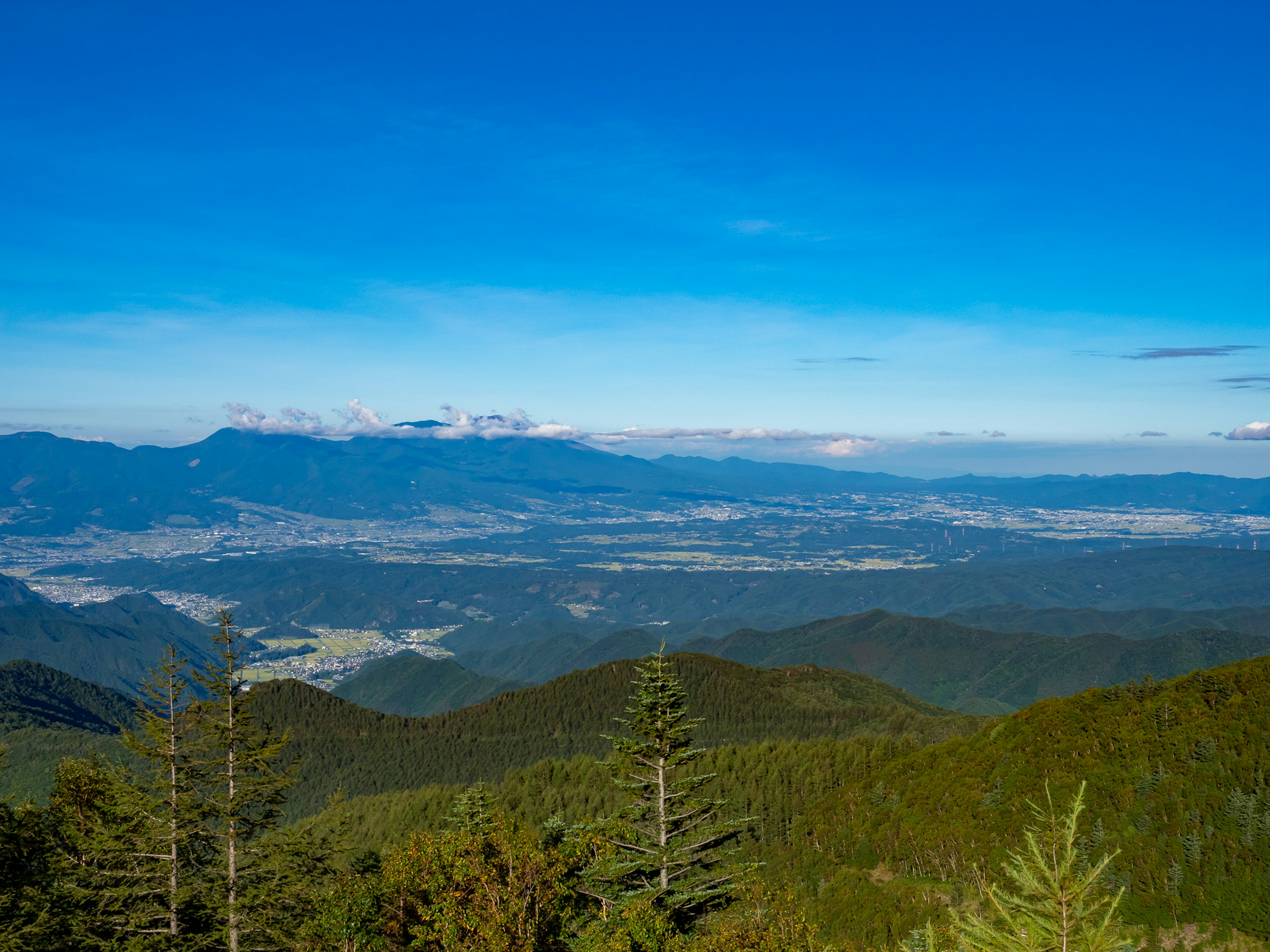 Scenic view of mountains and valleys under a blue sky