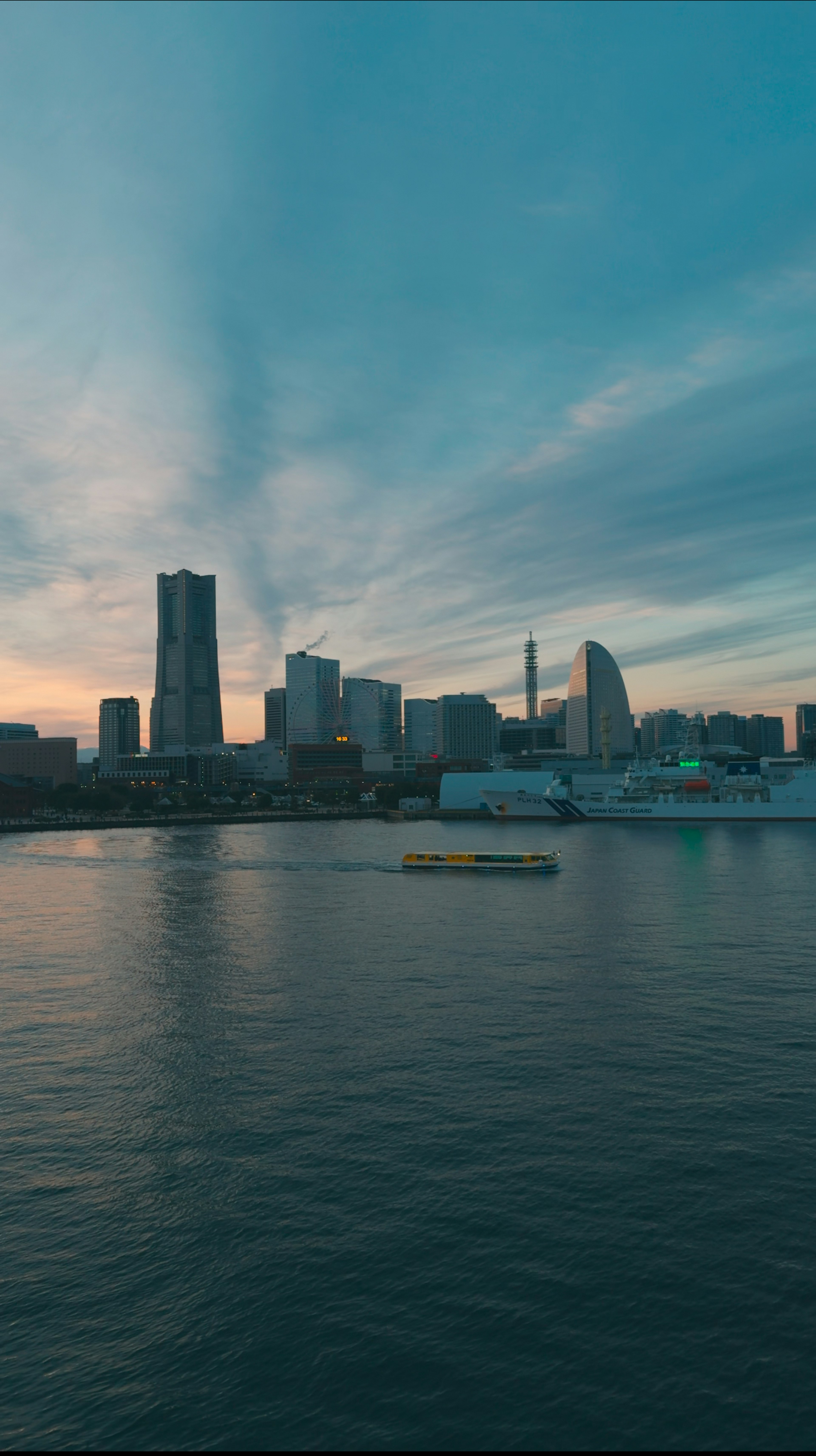 Beautiful skyline of Yokohama at sunset reflecting on the water