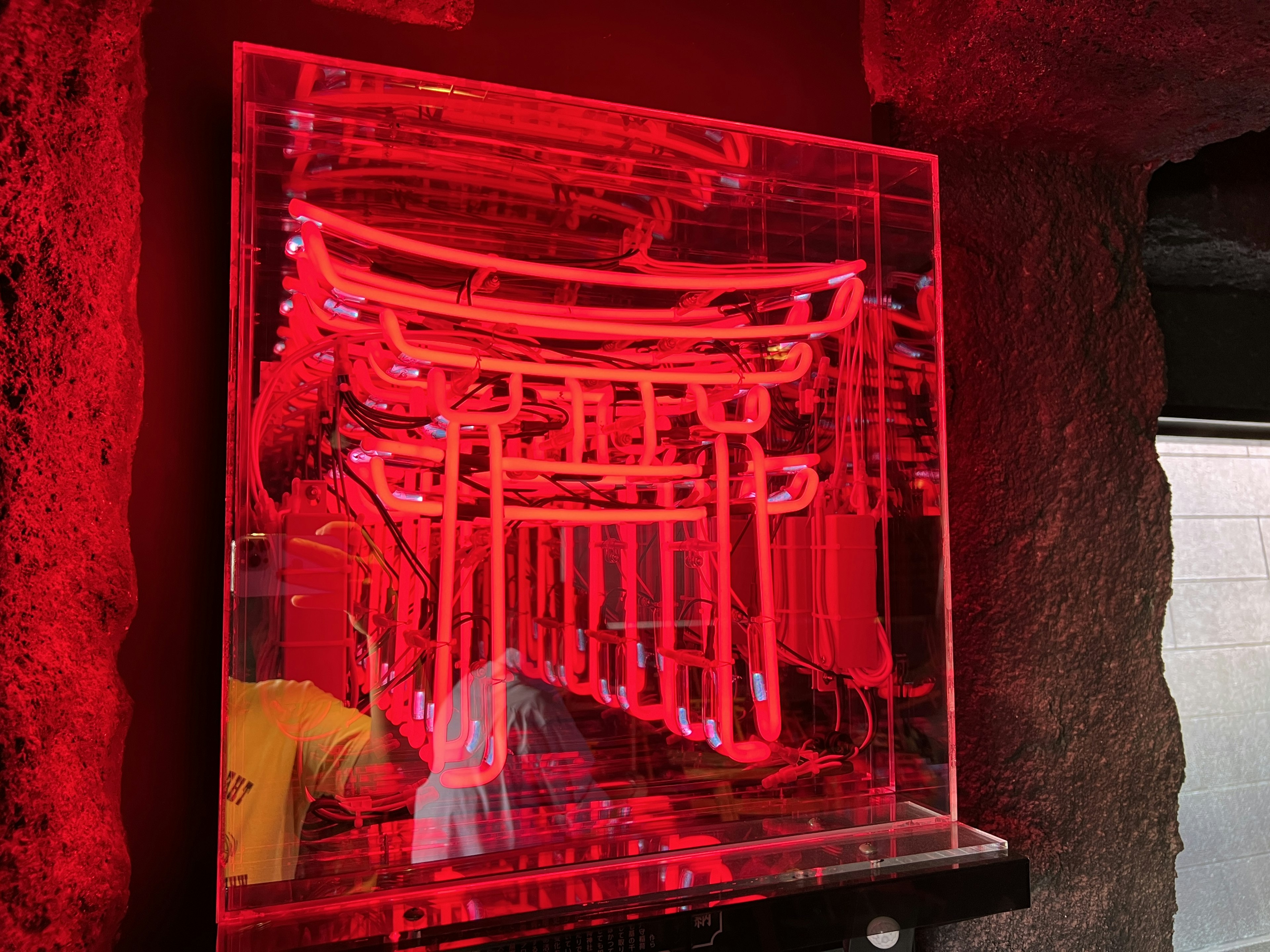 Neon art of torii gates illuminated in red