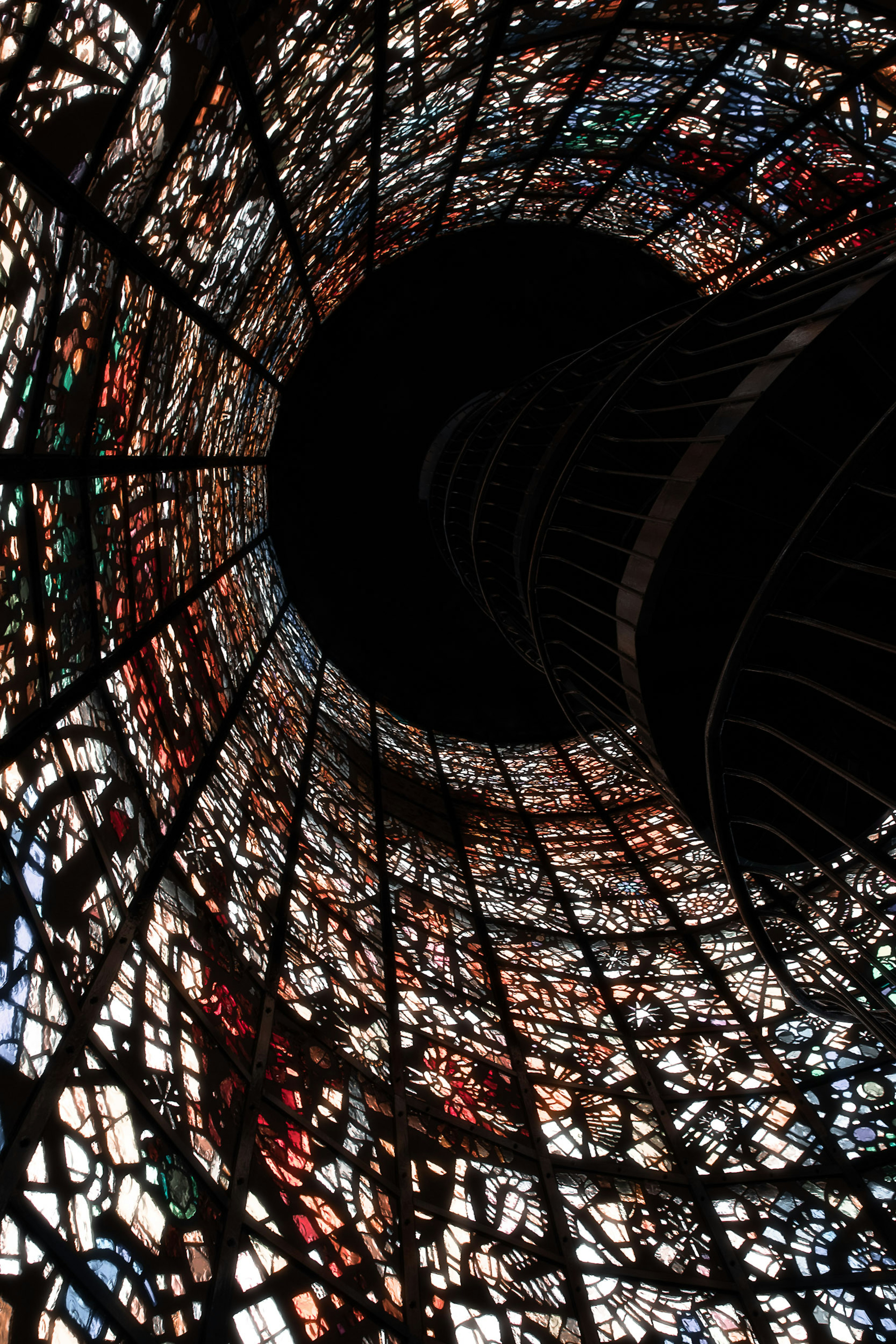 View looking up through a colorful stained glass tunnel