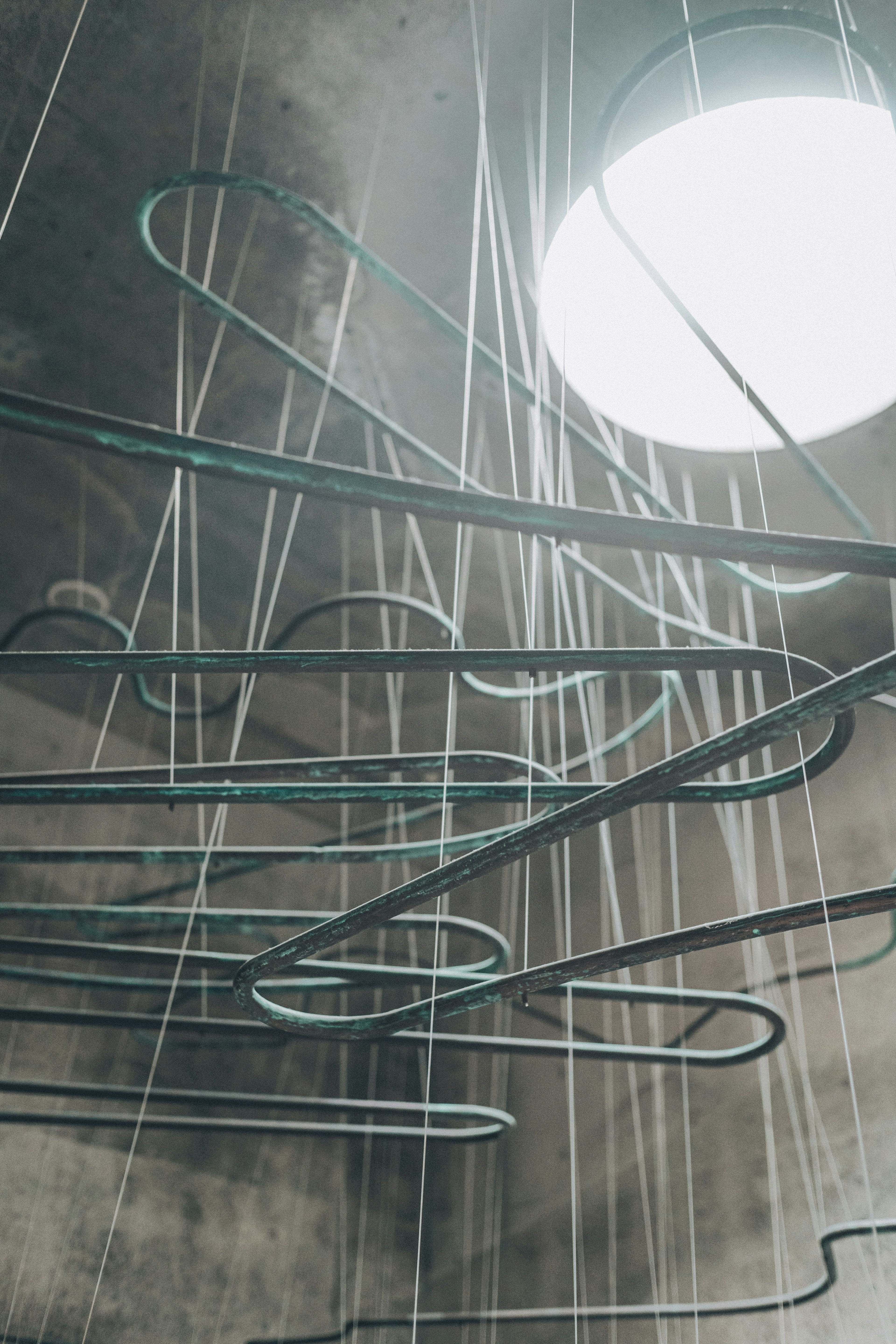 Curved metal pipes suspended from the ceiling in a unique space