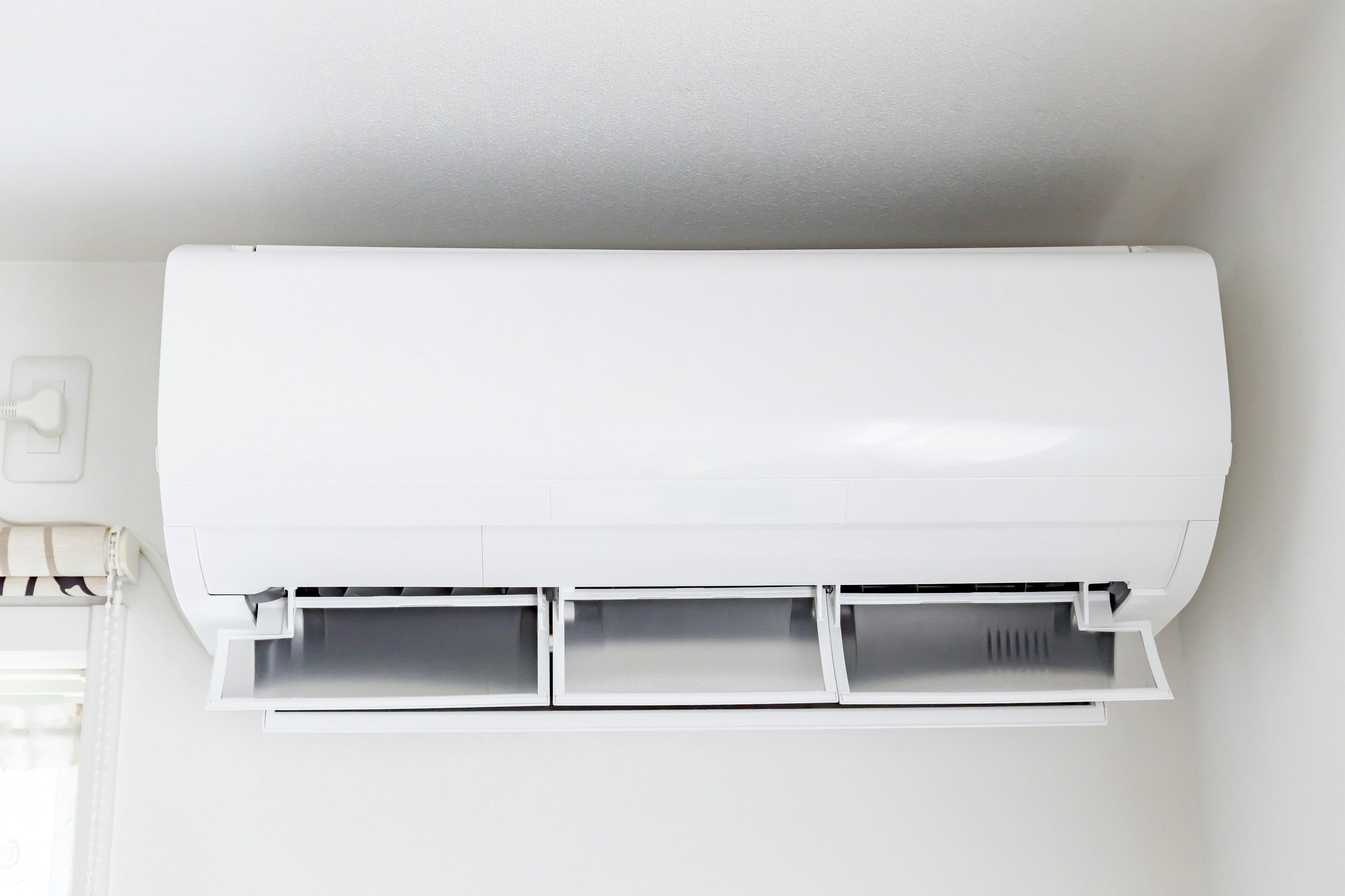 White air conditioner mounted on a wall in an interior room