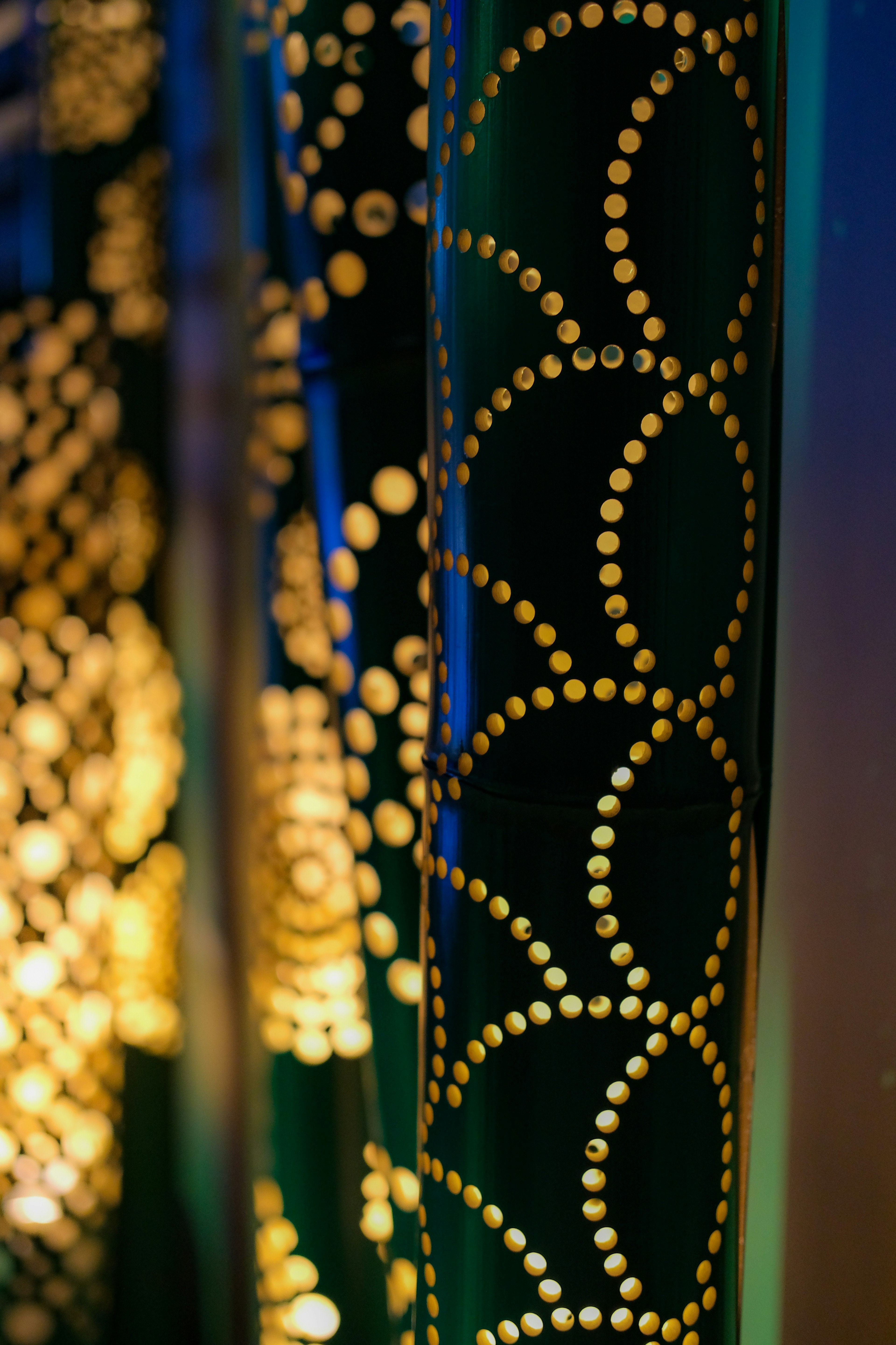 Close-up of decorative columns featuring golden circular patterns on a dark background