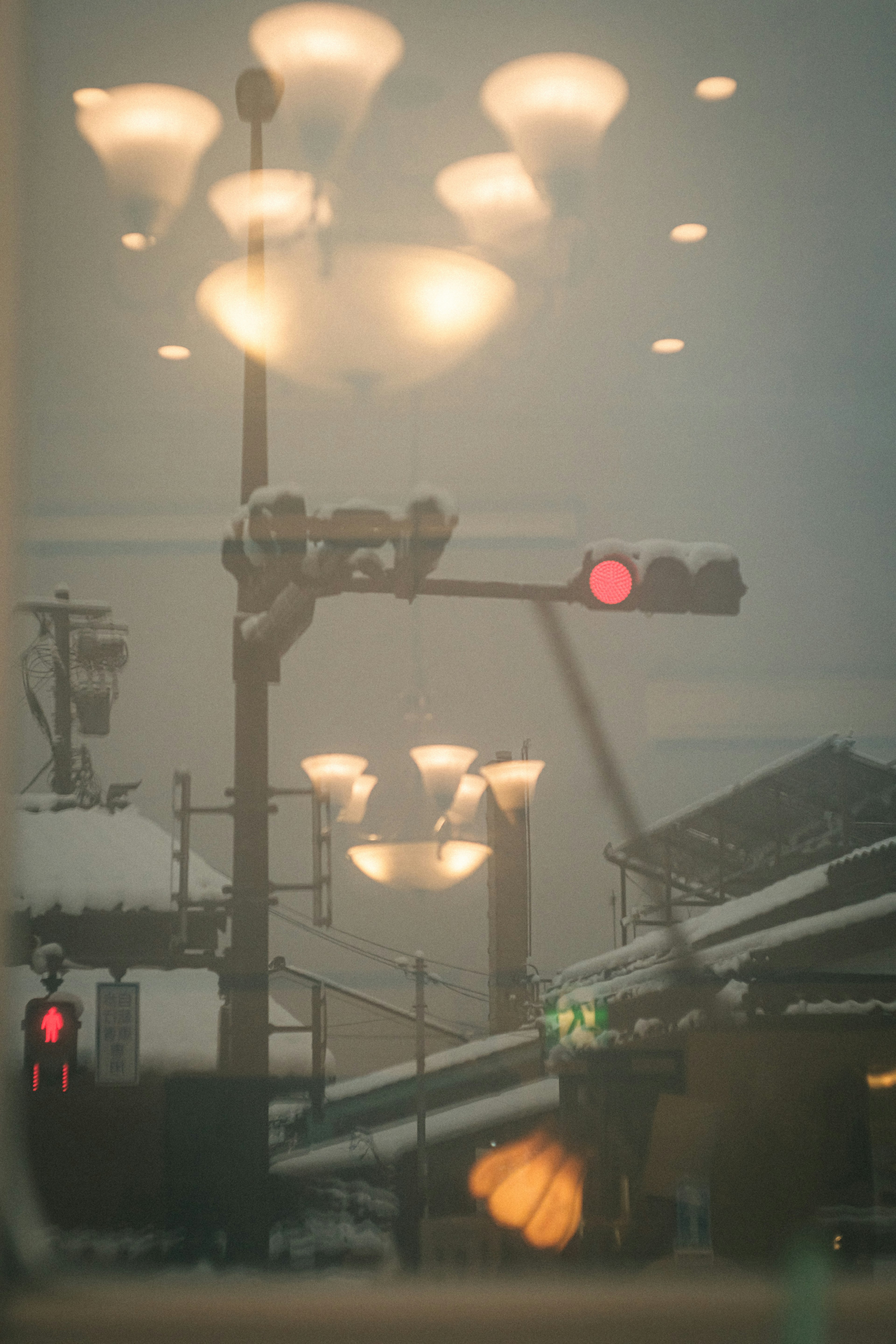 Reflejo de semáforos y farolas visto a través de una ventana