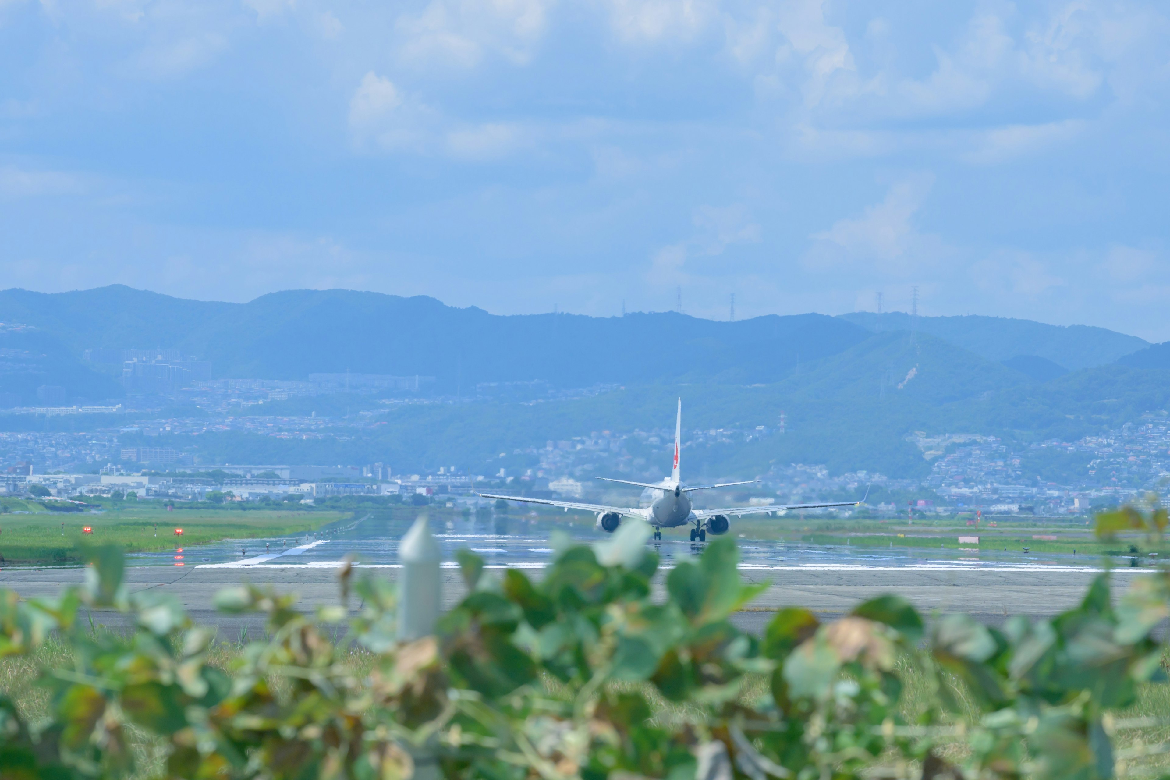 Airplane on the runway with mountains in the background