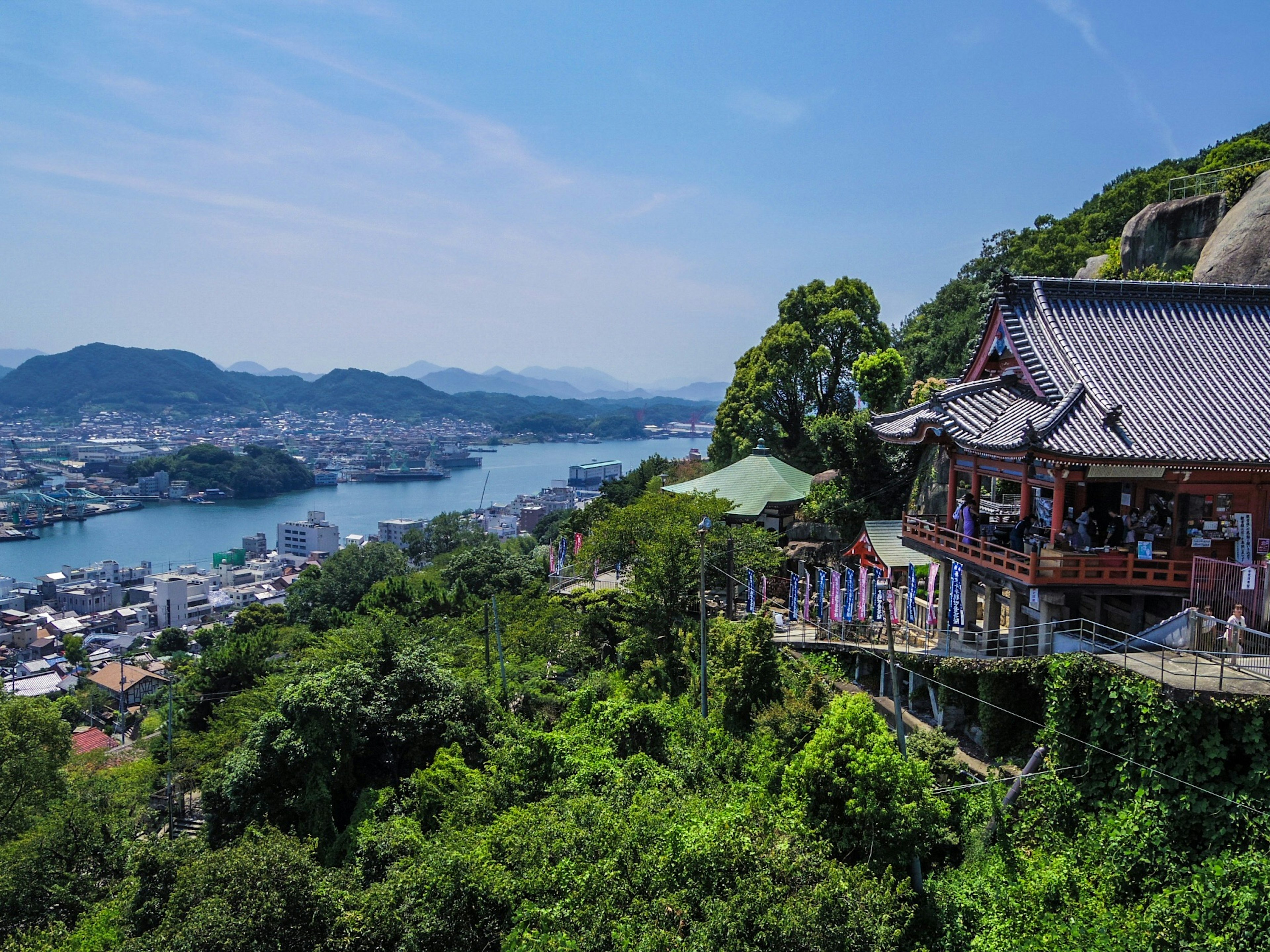 Scenic view of a temple on a hill overlooking a river and town