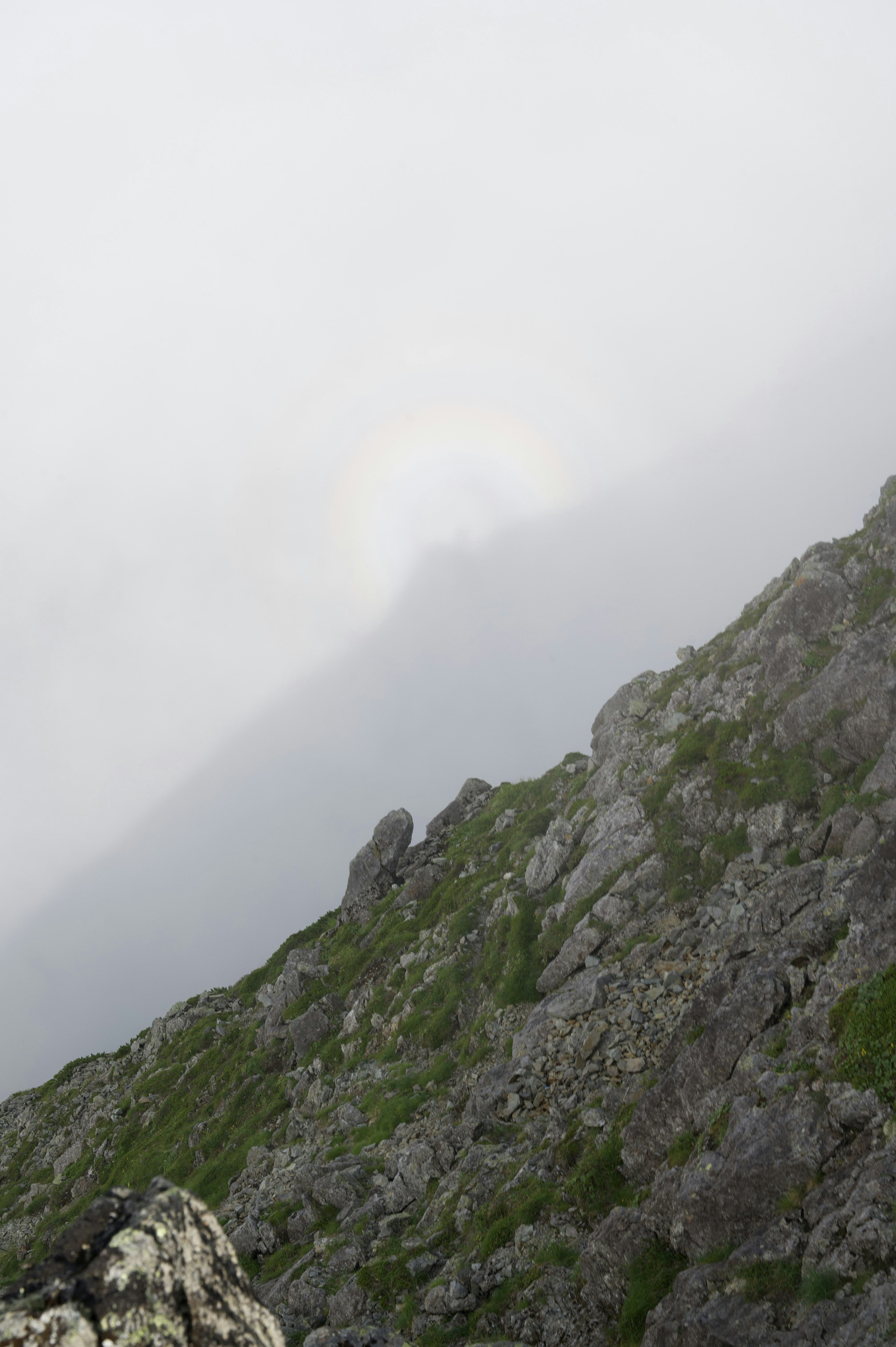 Mountain landscape shrouded in fog with rocky texture