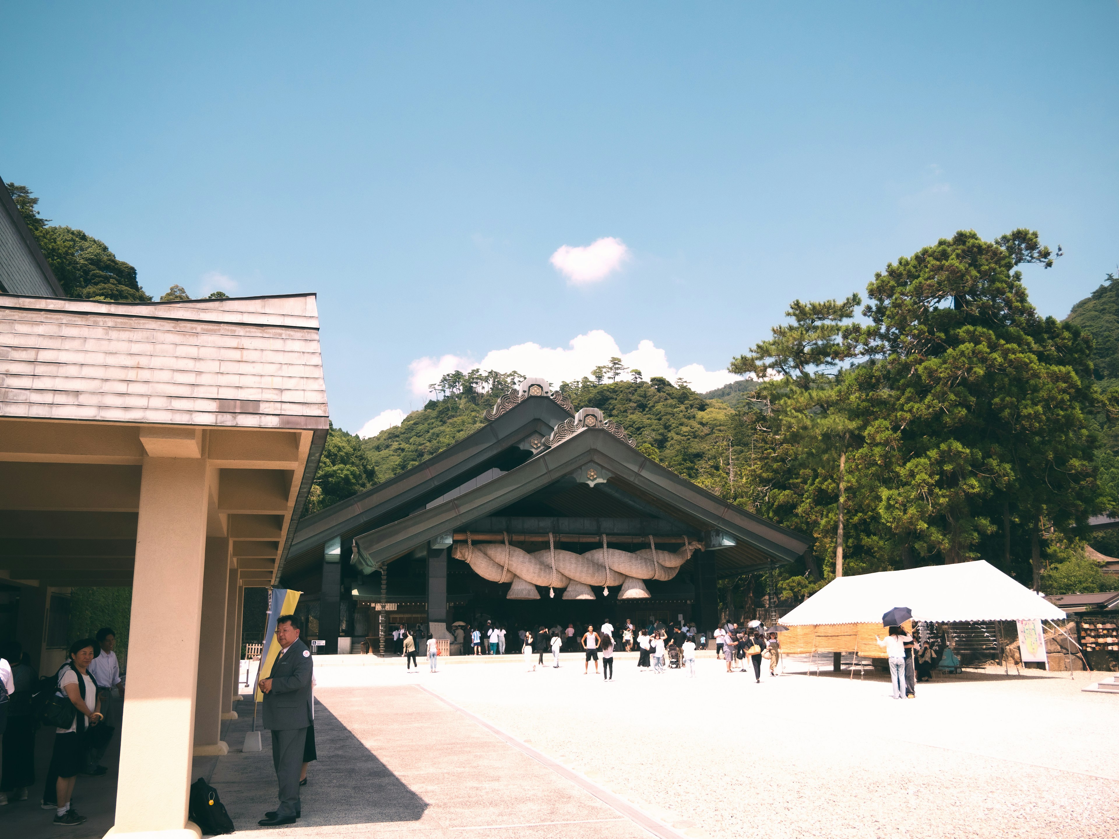 Traditional building under blue sky with a gathering of people