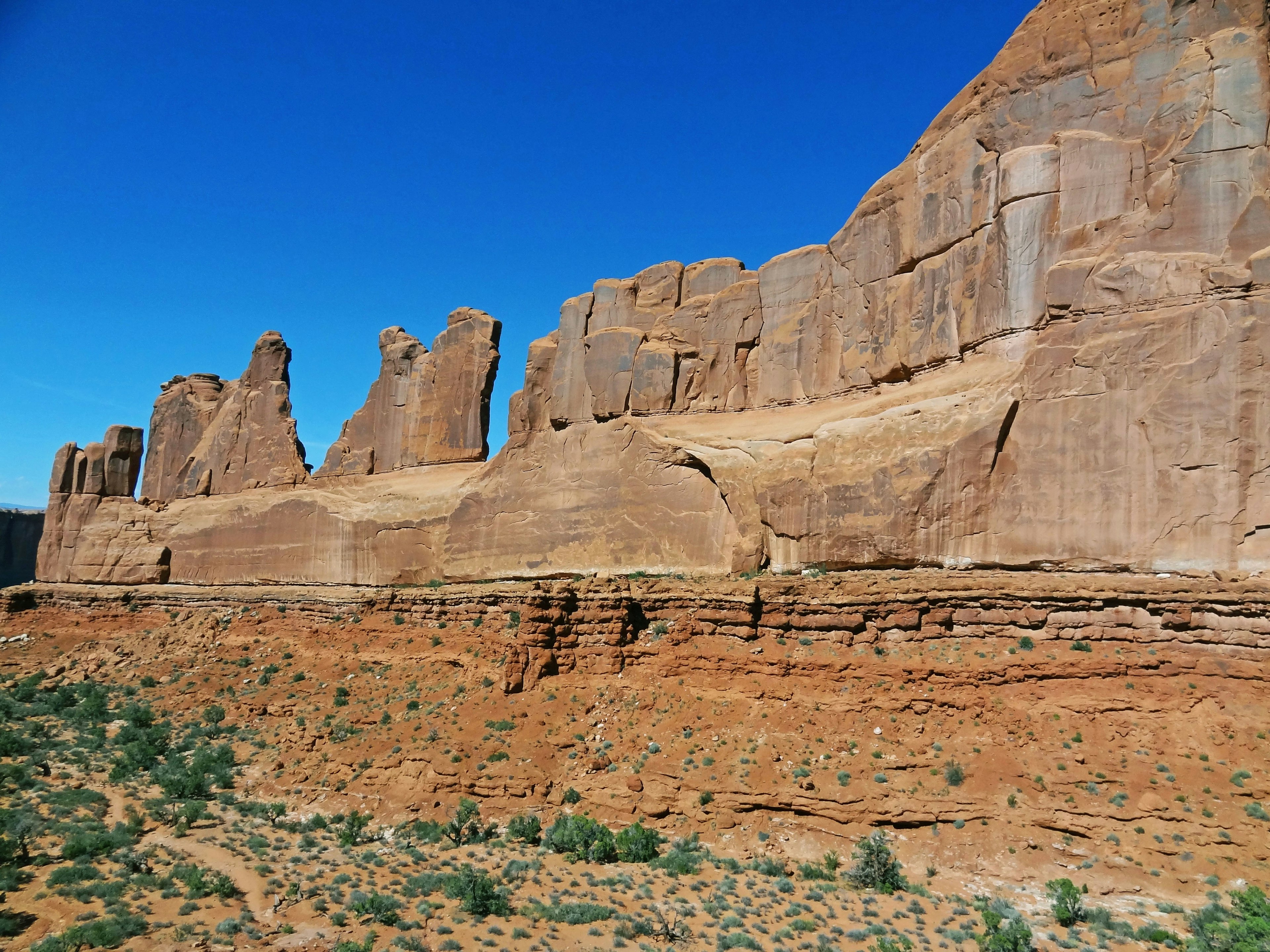 Red rock cliffs under a clear blue sky