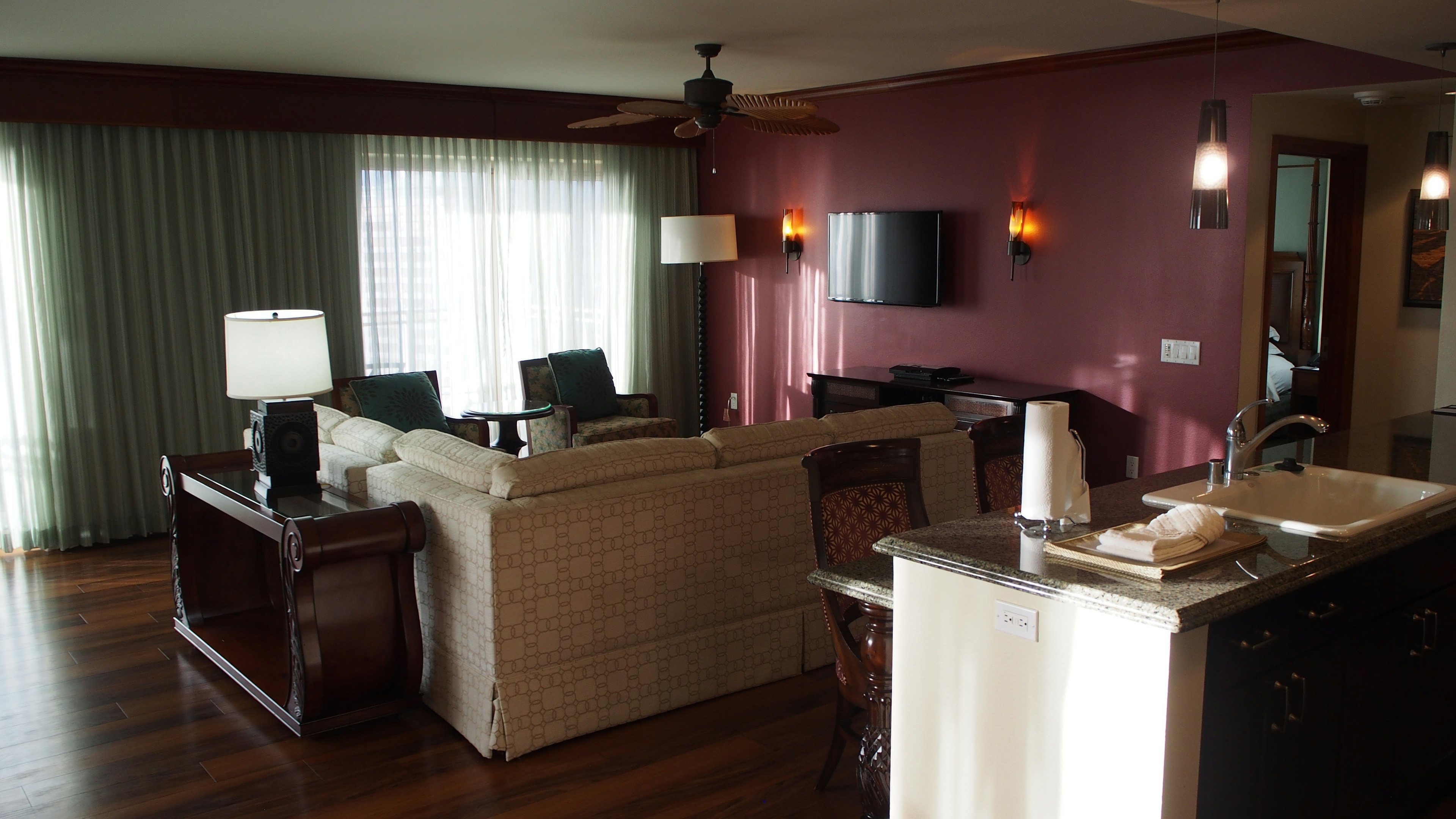 Cozy living room and dining area with a sofa and TV warm-colored walls