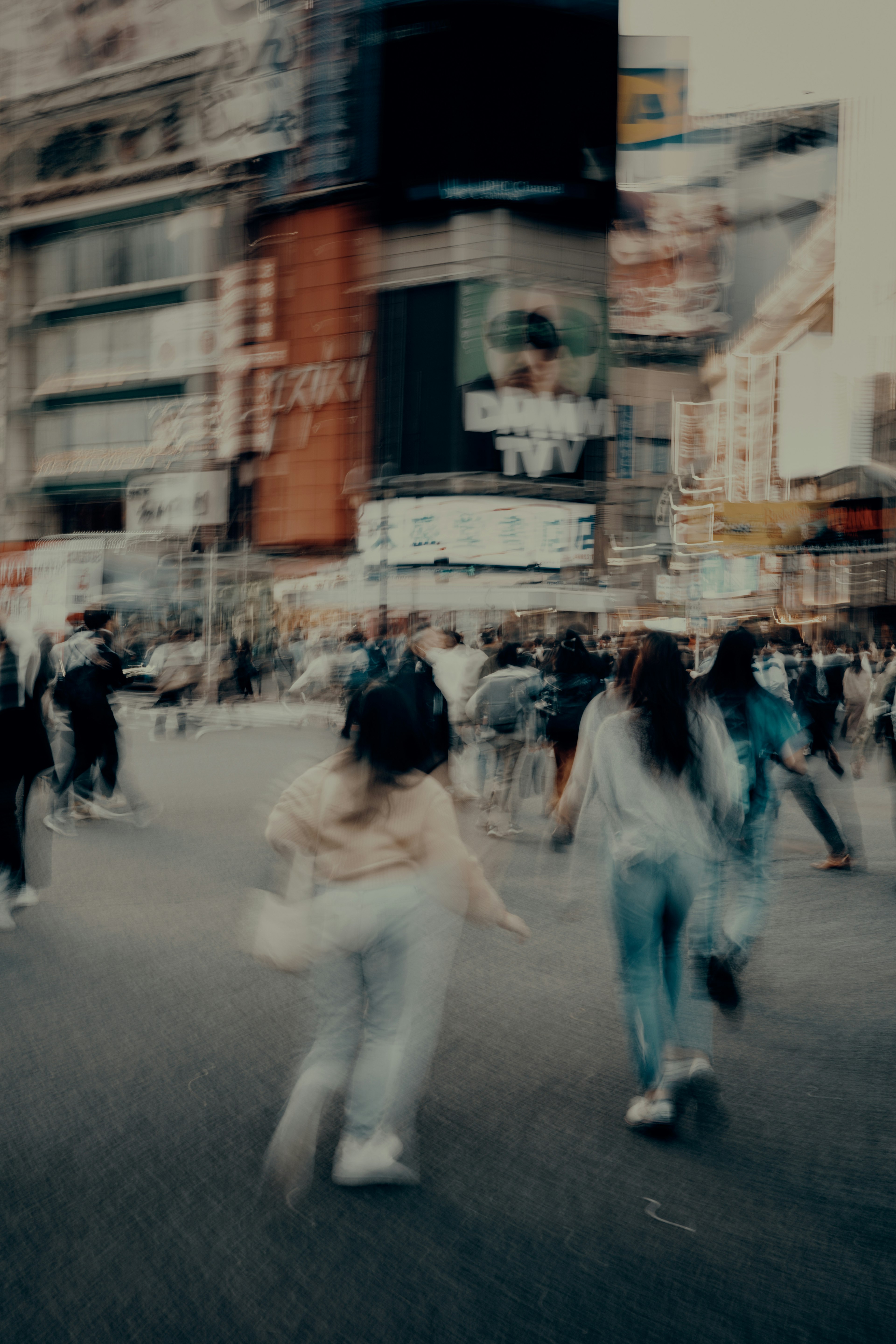 Blurred street scene with people running in a busy urban area