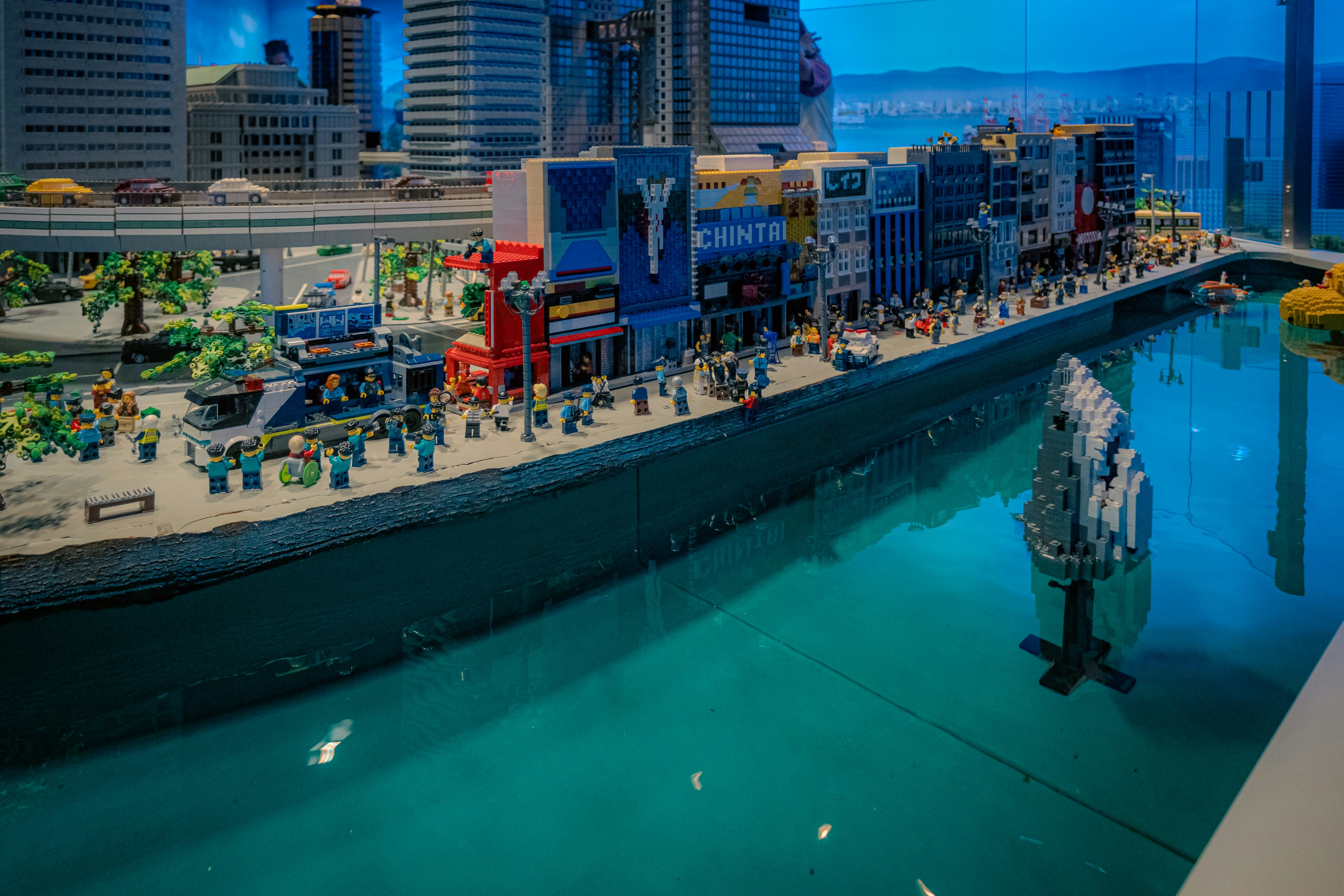 Lego cityscape with a waterfront and a fish model