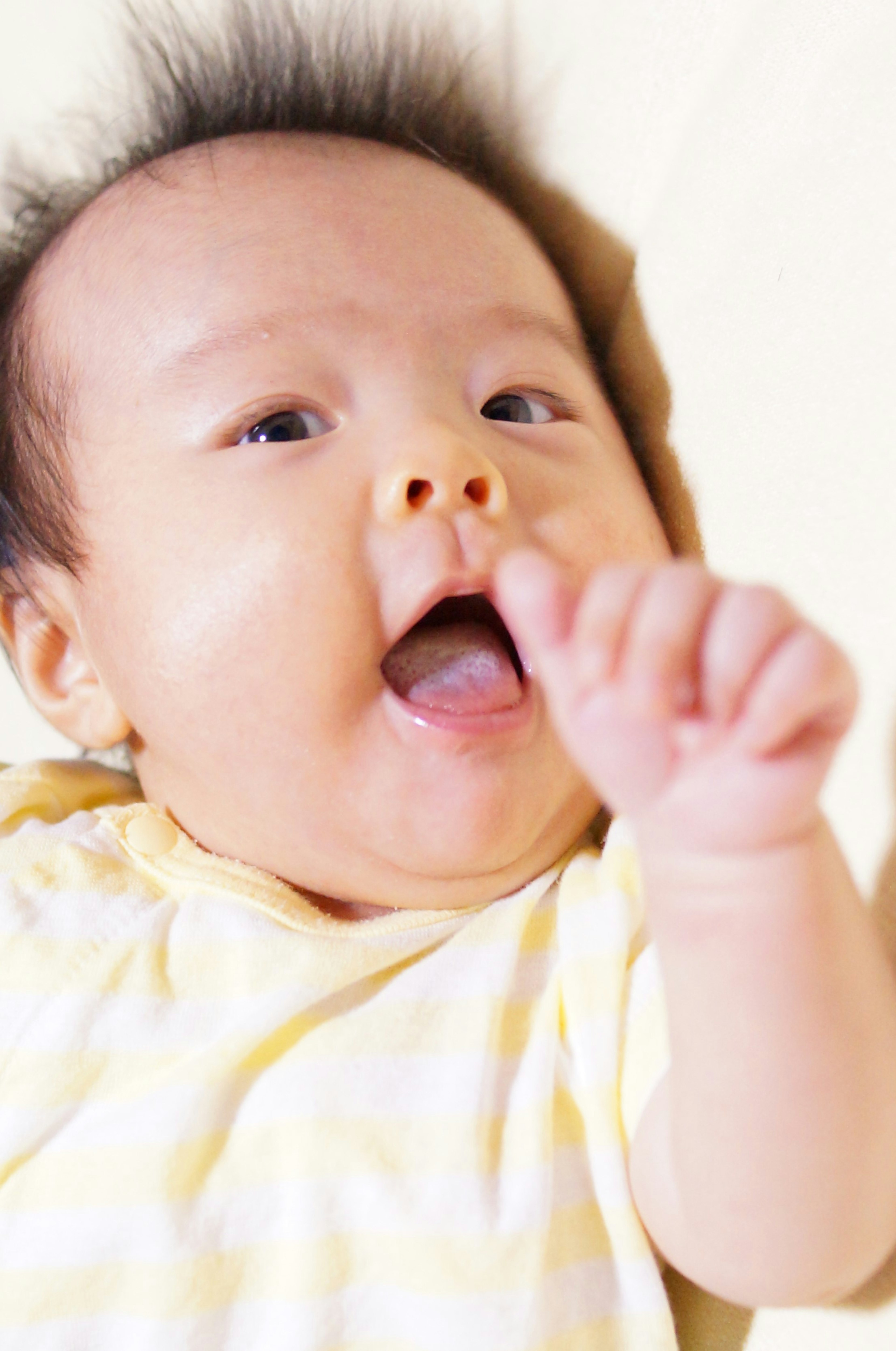 Baby smiling and raising hand