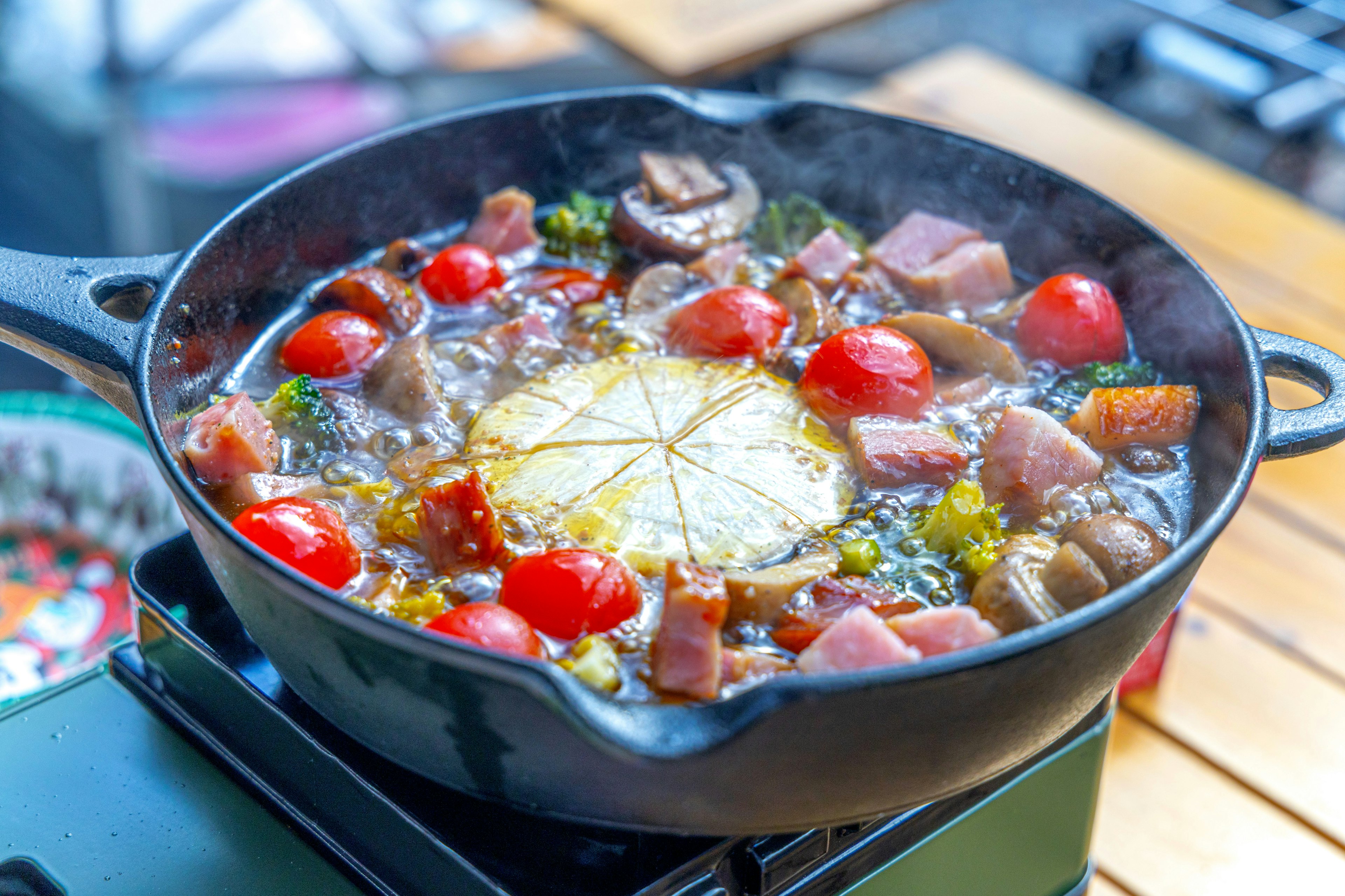 A vibrant dish in a pot with various ingredients and a slice of lemon