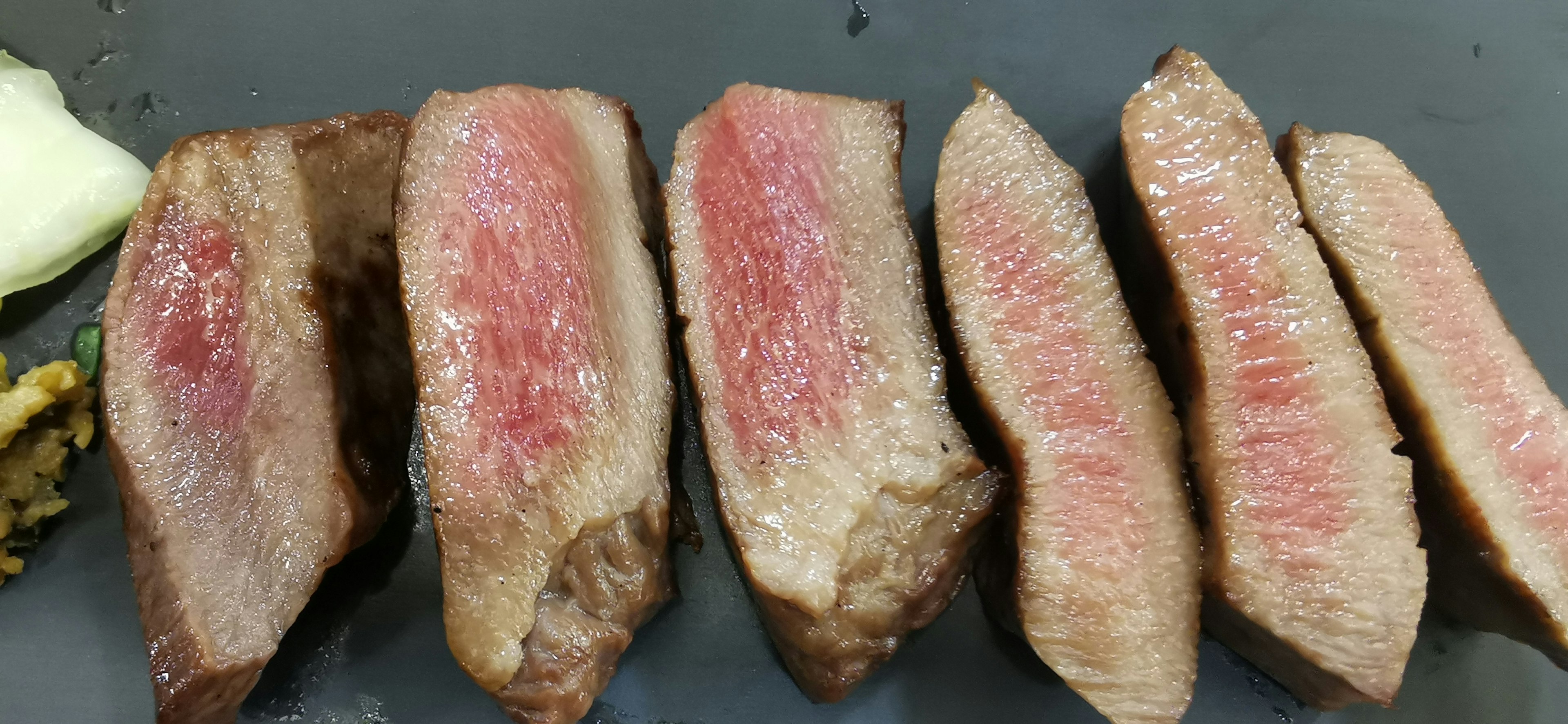 Sliced beef steak arranged on a plate showcasing tender meat