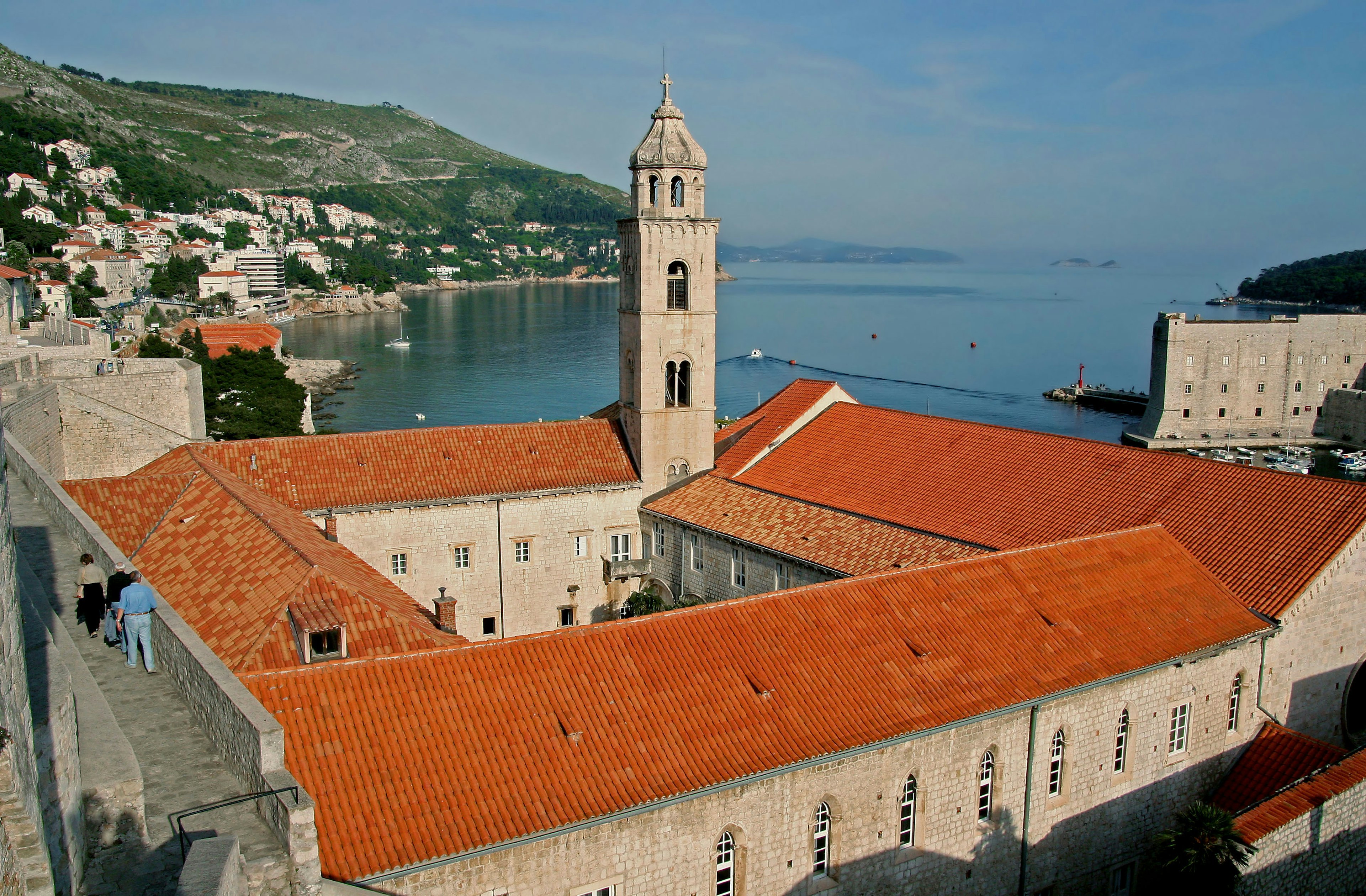 Scenic view featuring a coastal landscape and a church with red roofs