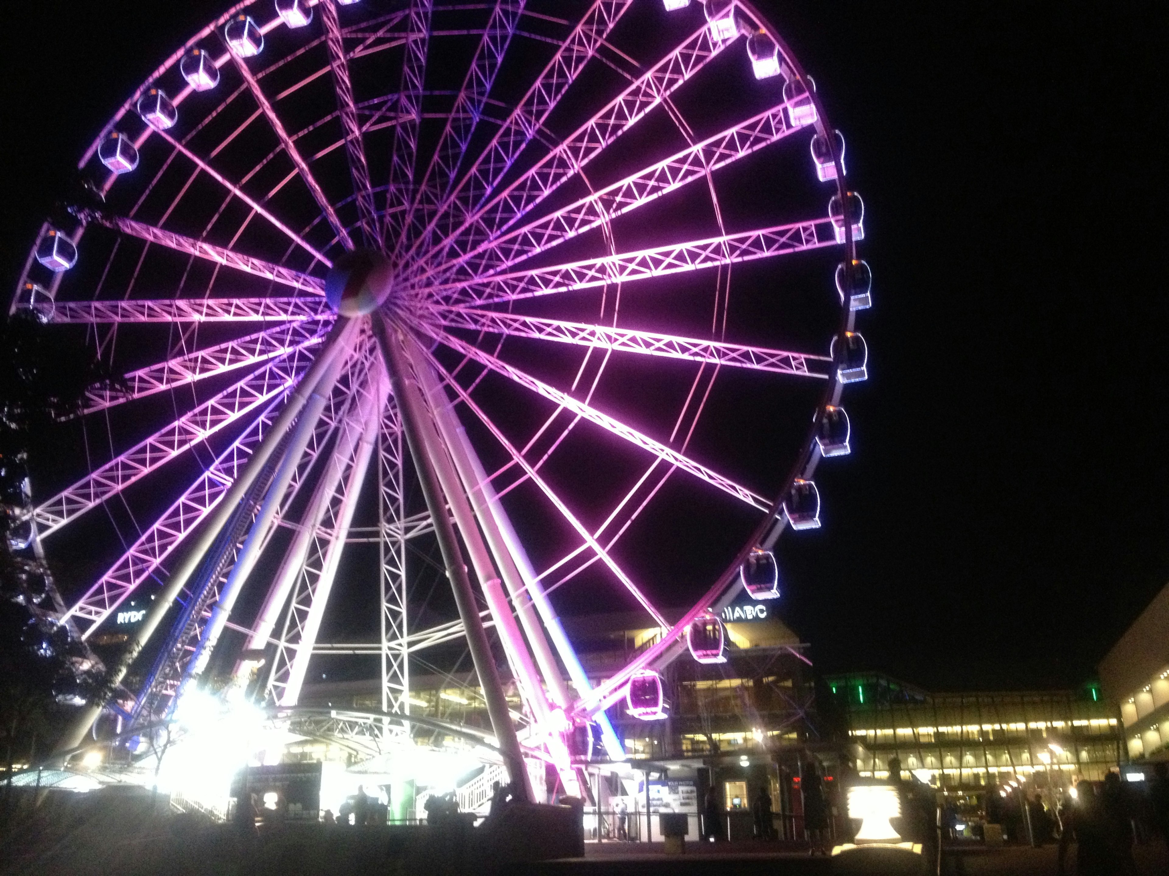 Illuminated Ferris wheel at night with vibrant colors