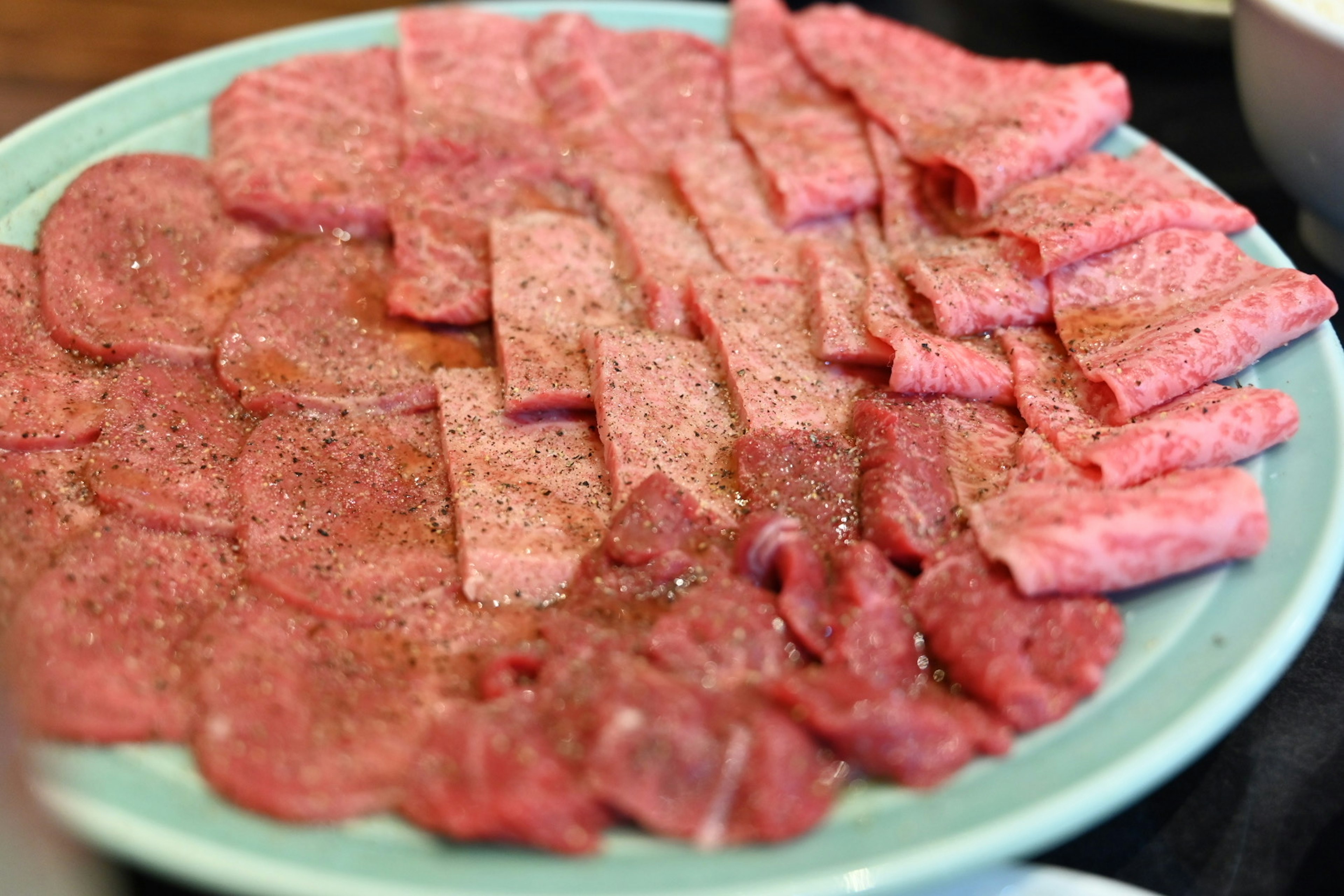 Plate of assorted sliced meats arranged neatly