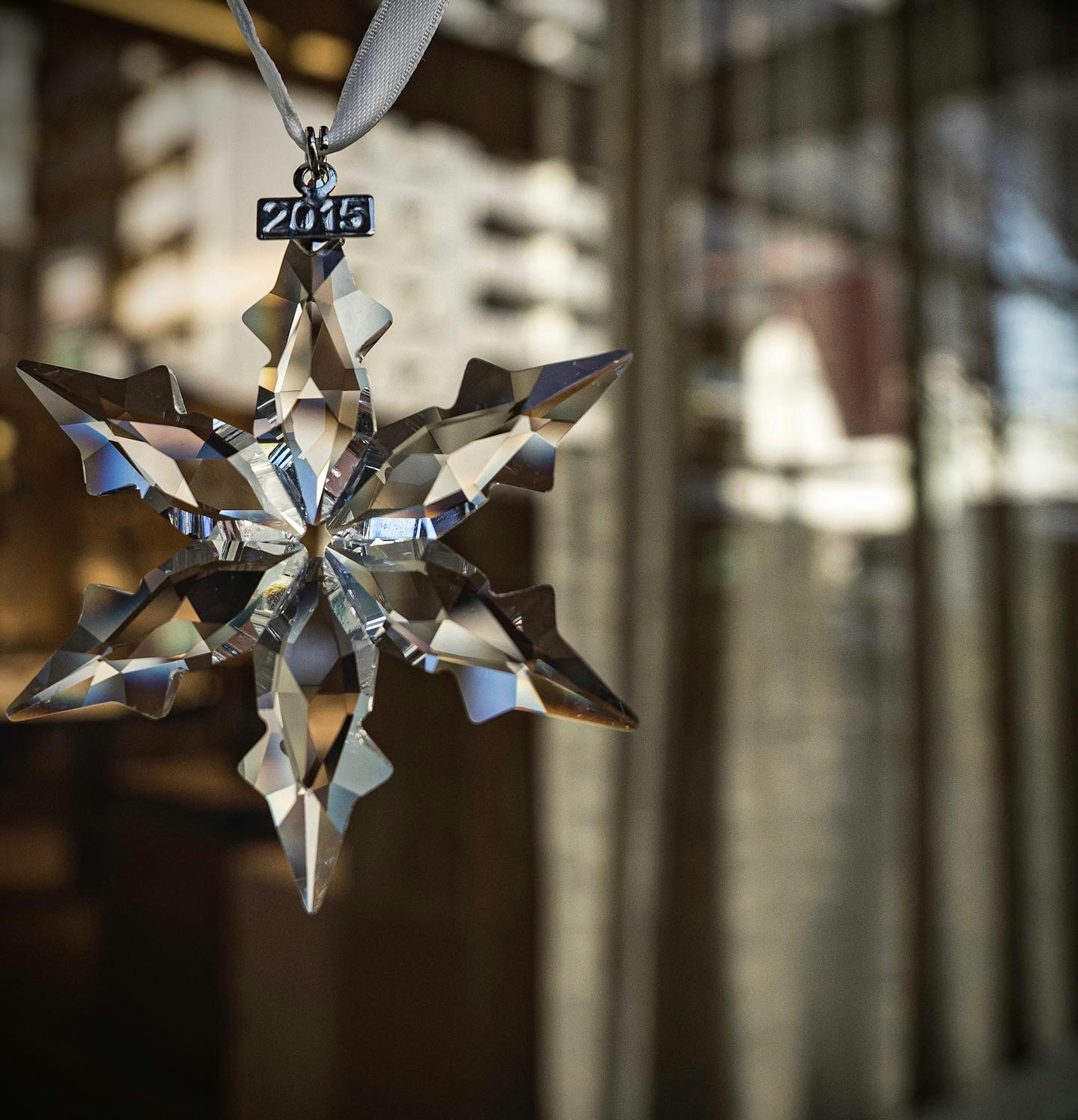 A clear crystal snowflake ornament reflecting light