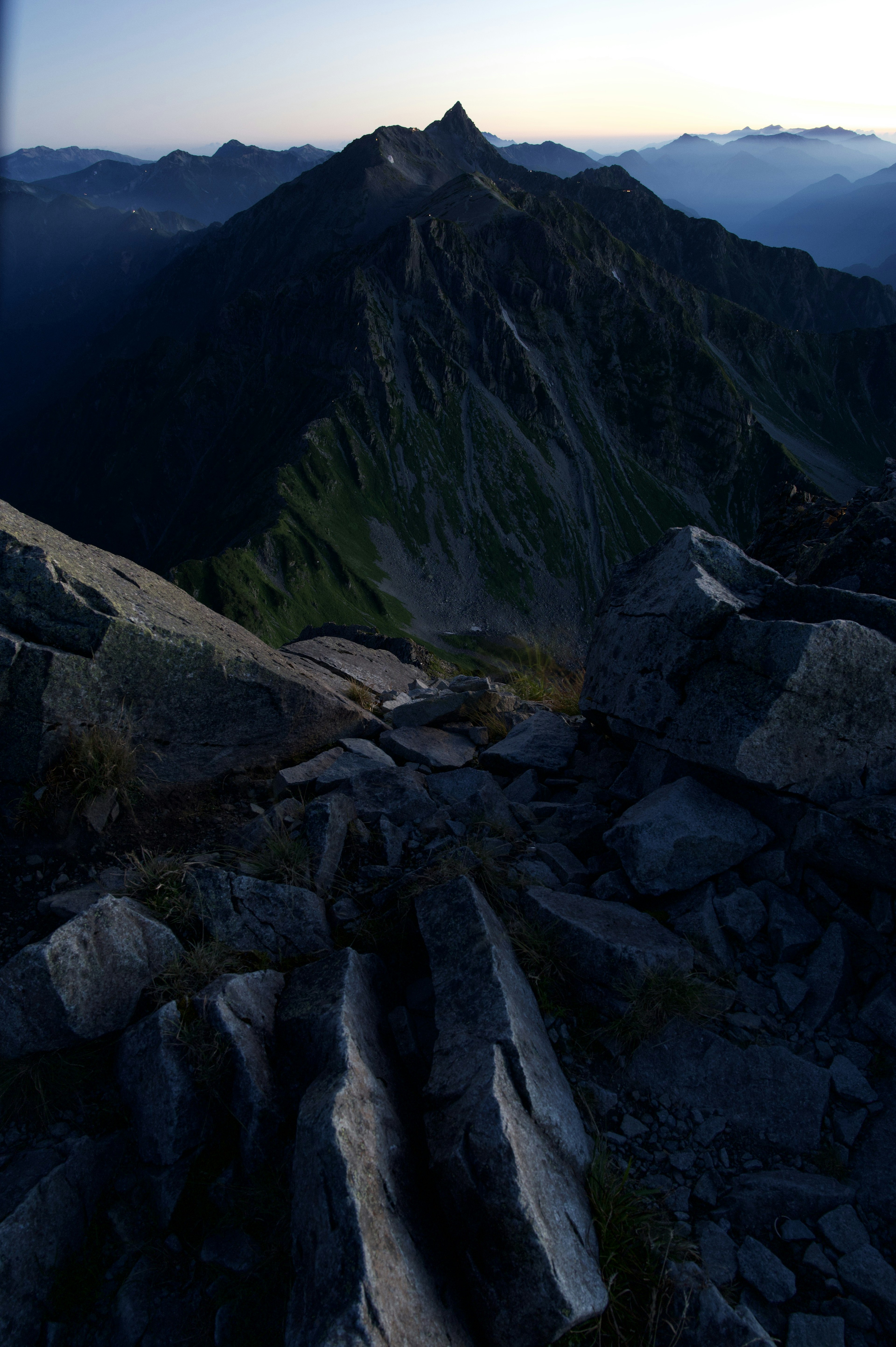 Mountain peak and rocky landscape at dusk with blue sky