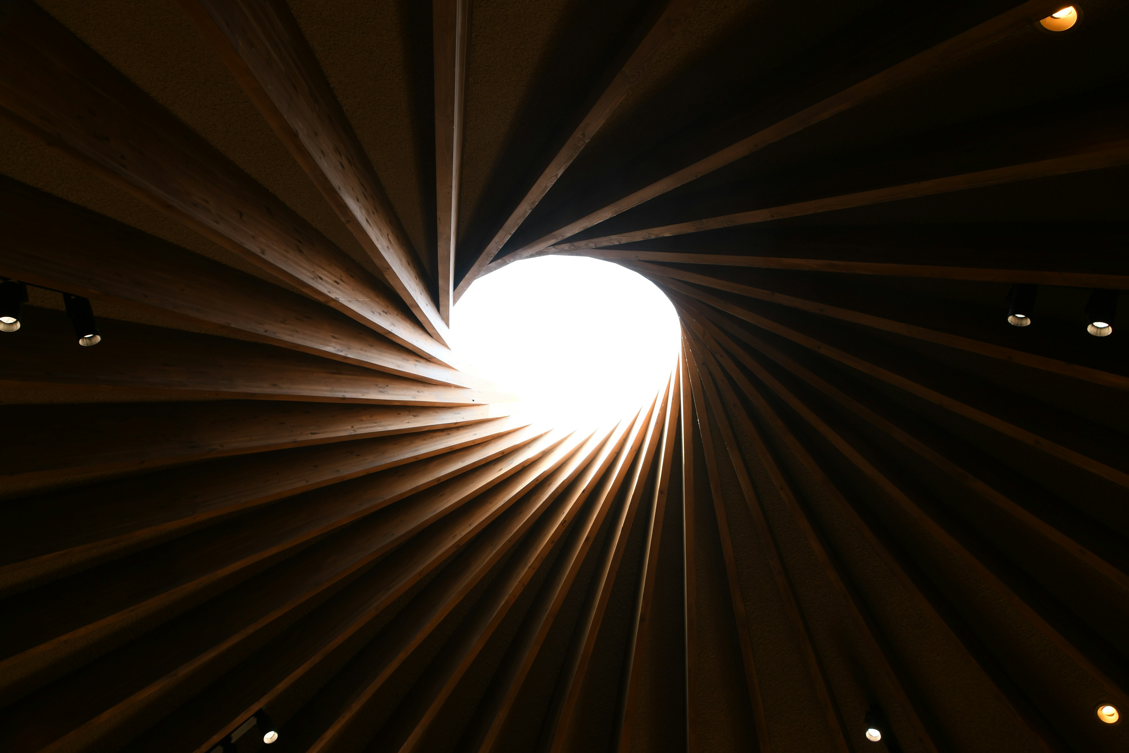 Interior of a spiral ceiling with bright light at the center