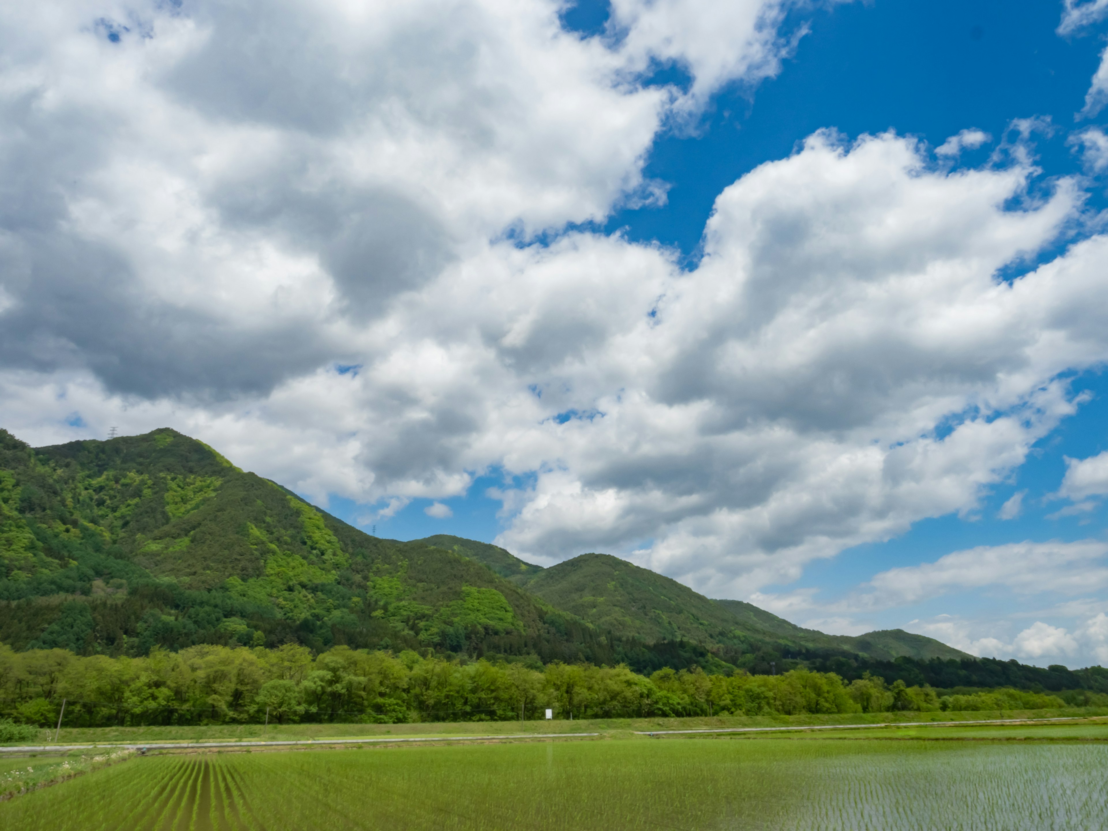 Beautiful landscape with blue sky and white clouds Green mountains and rice fields