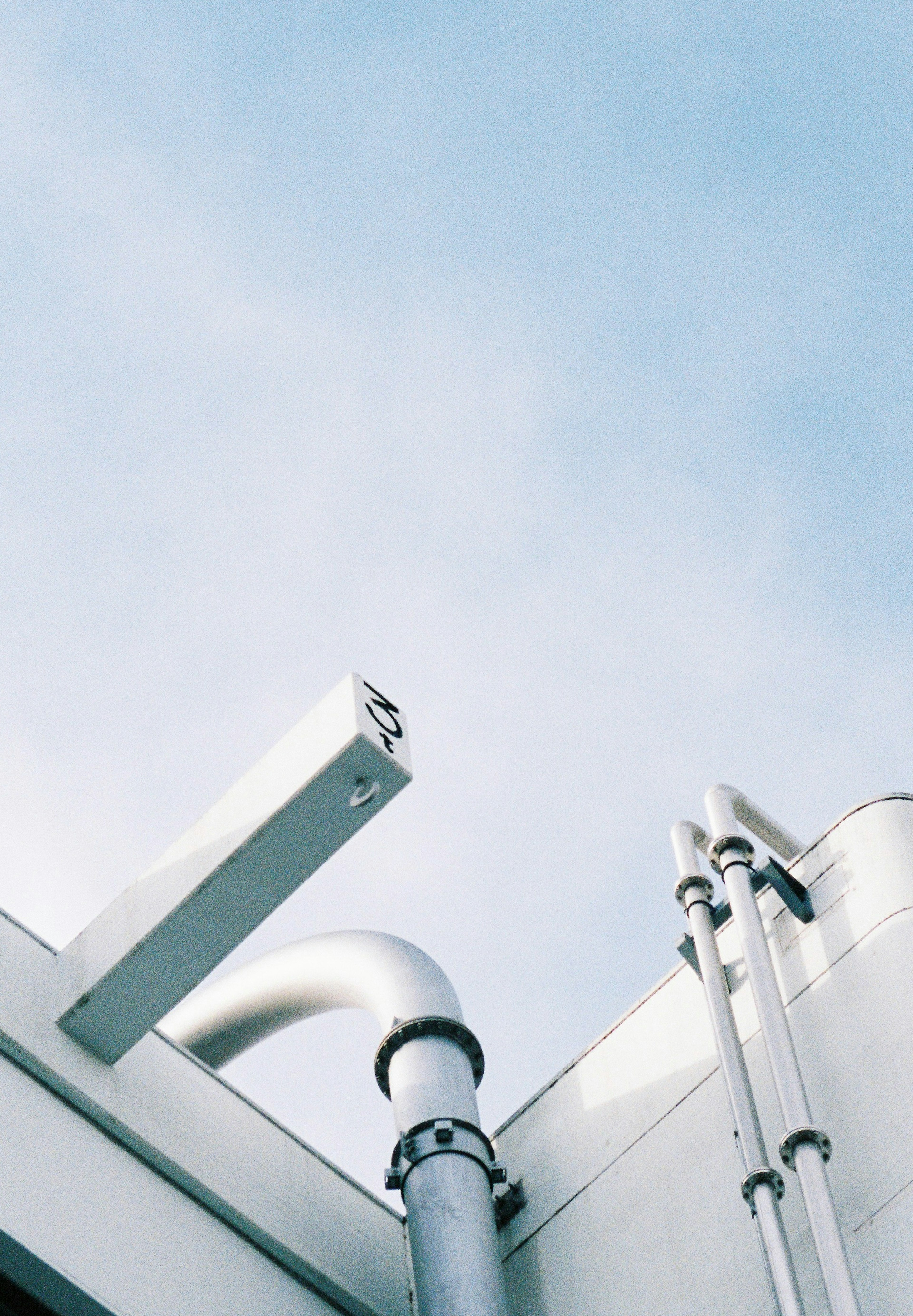 Metal pipes and structure against a blue sky