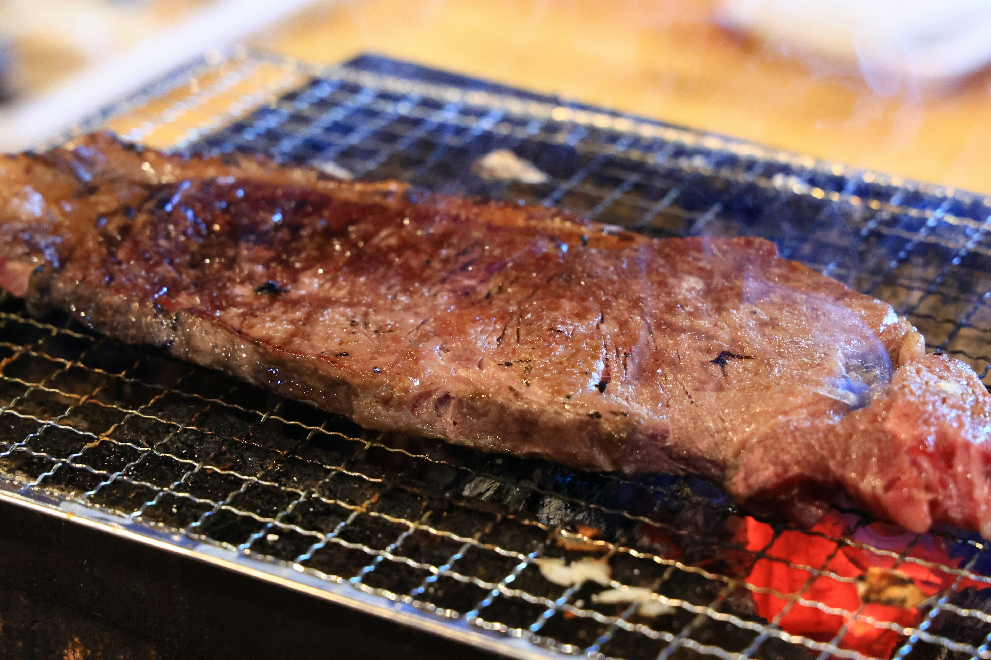 Grilled slice of meat resting on a barbecue grill