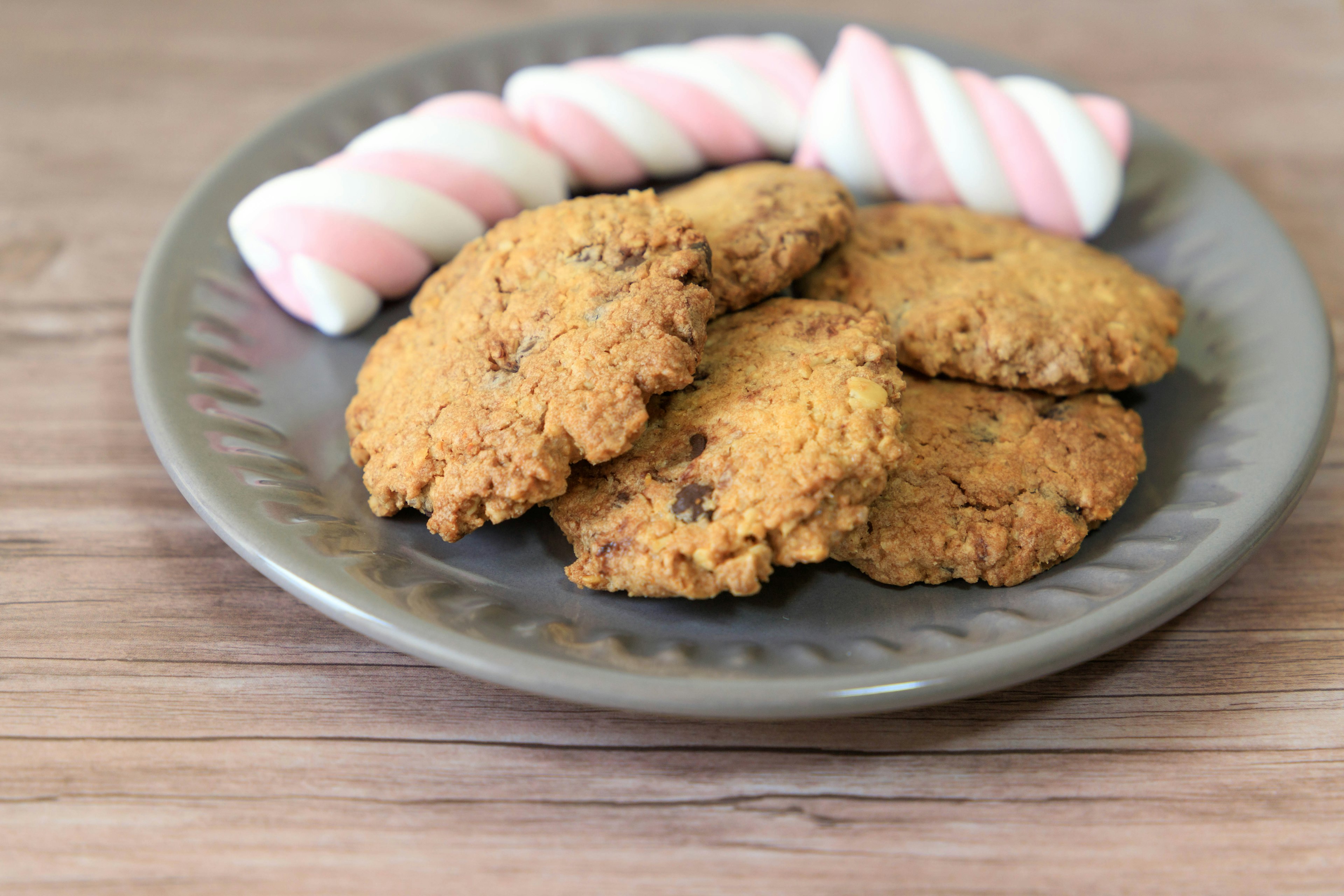 Brown cookies and pink and white marshmallows on a plate