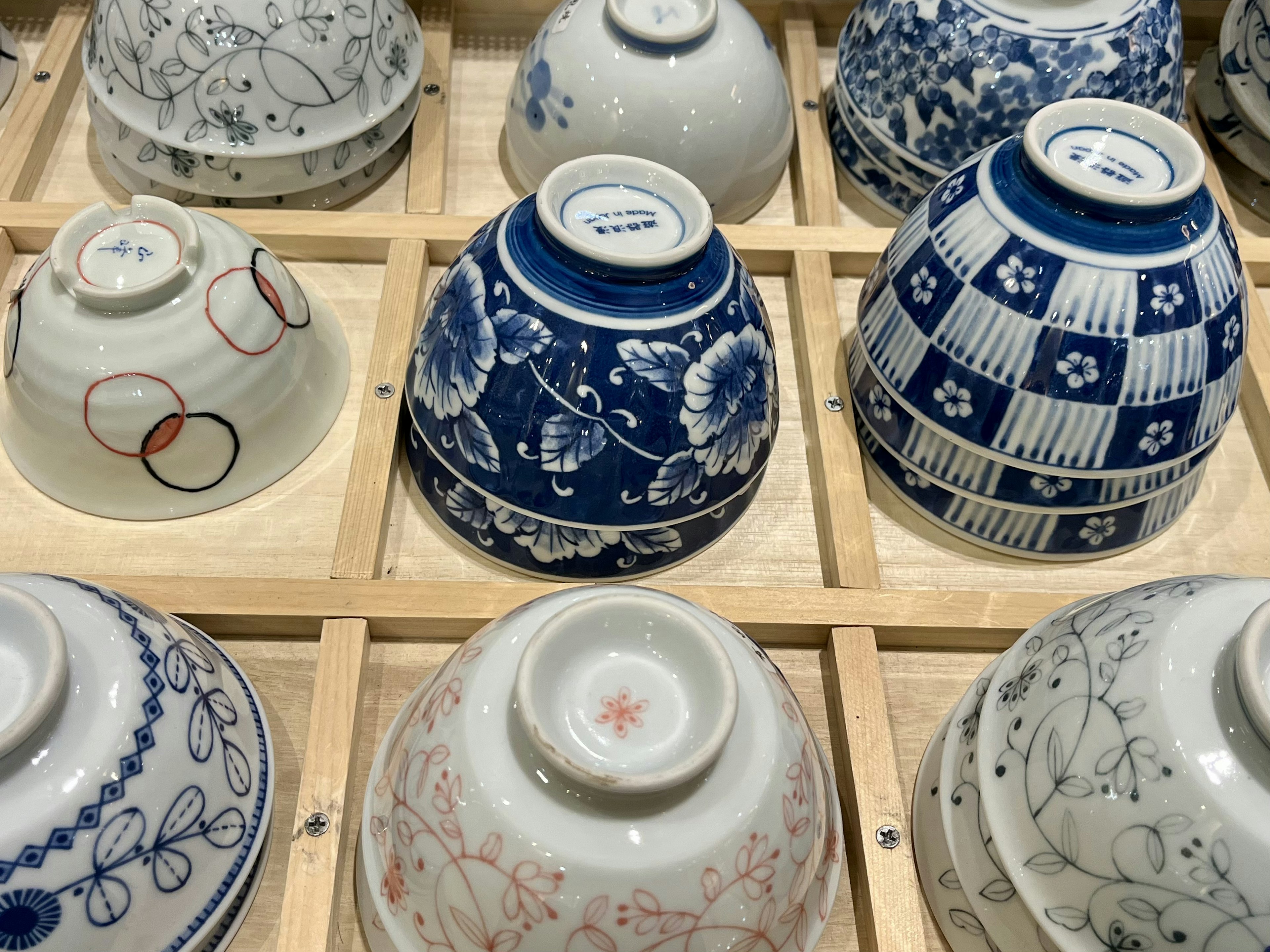 Blue and white ceramic bowls arranged in a wooden box