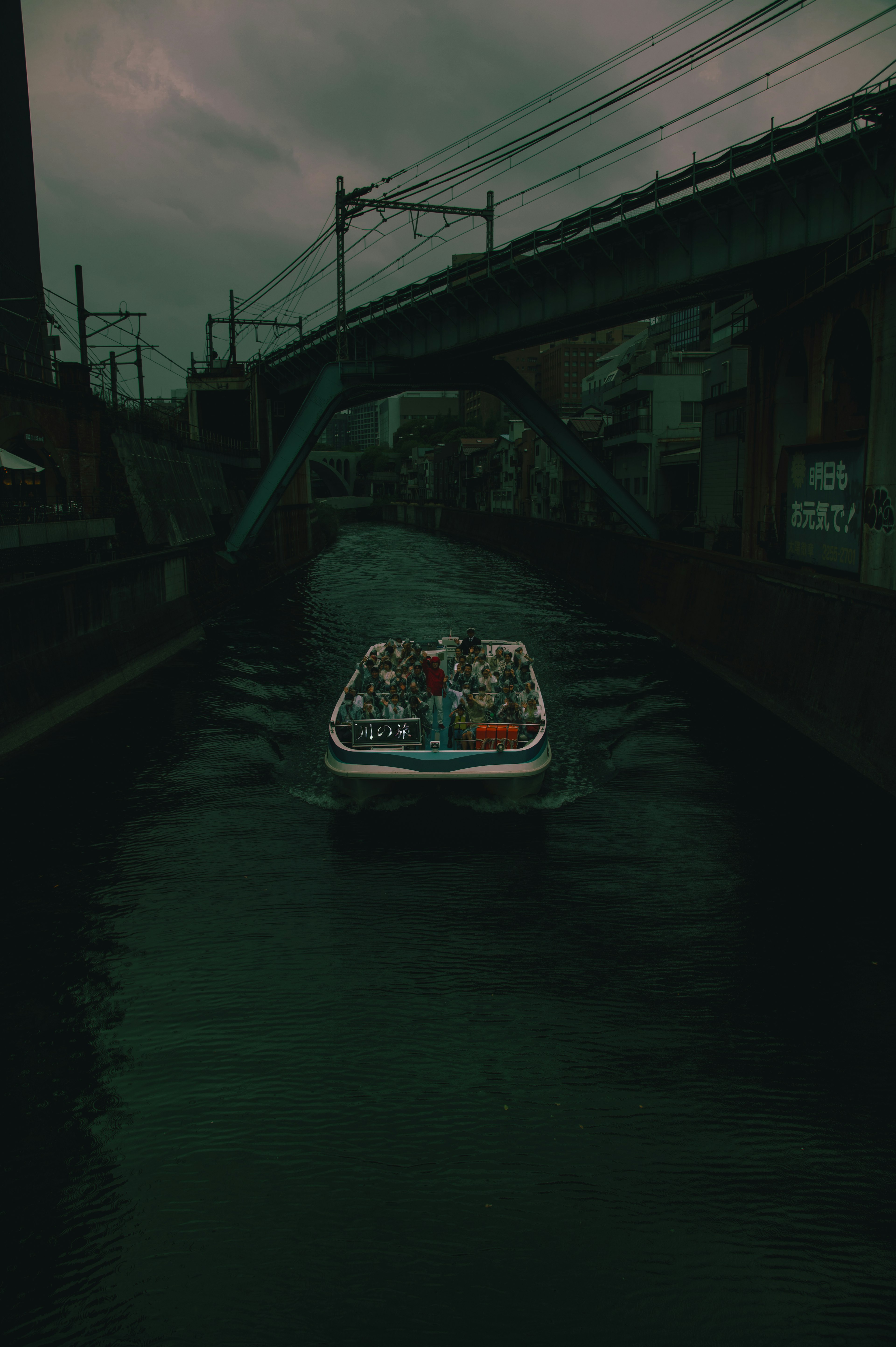 Boot, das einen dunklen Kanal unter einer Brücke durchfährt