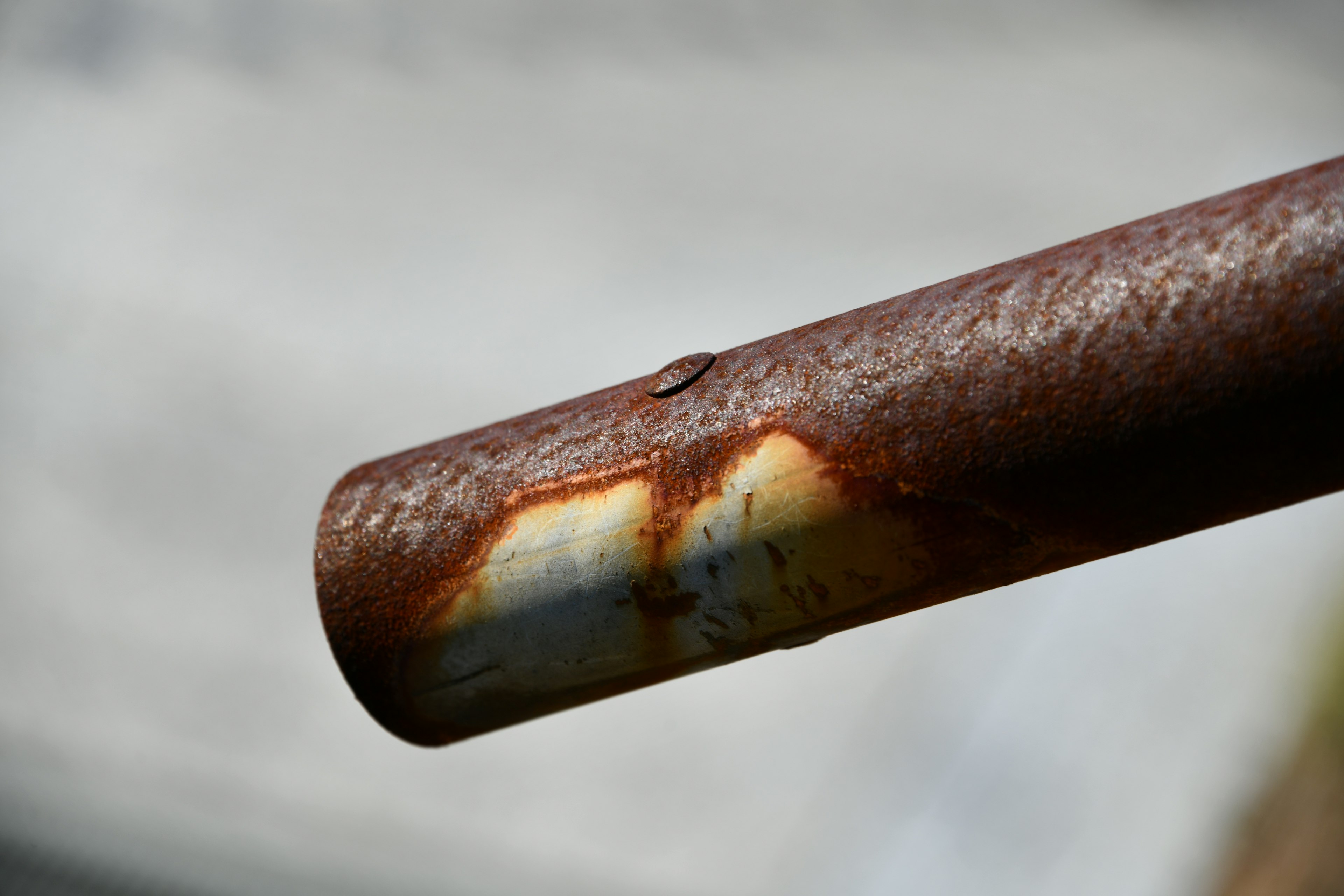 Close-up image of a rusty metal pipe