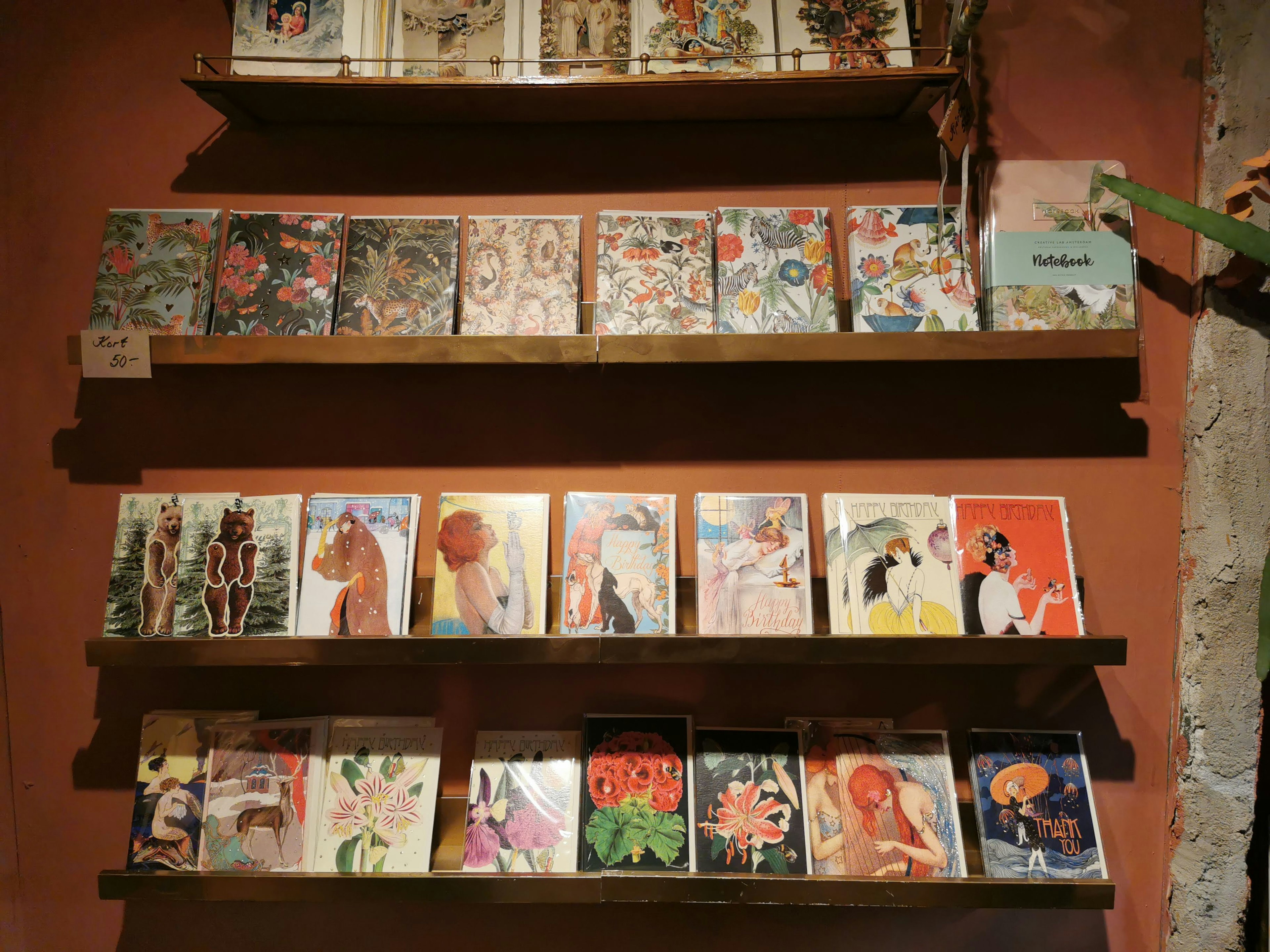 Colorful magazine covers displayed on wooden shelves against a wall