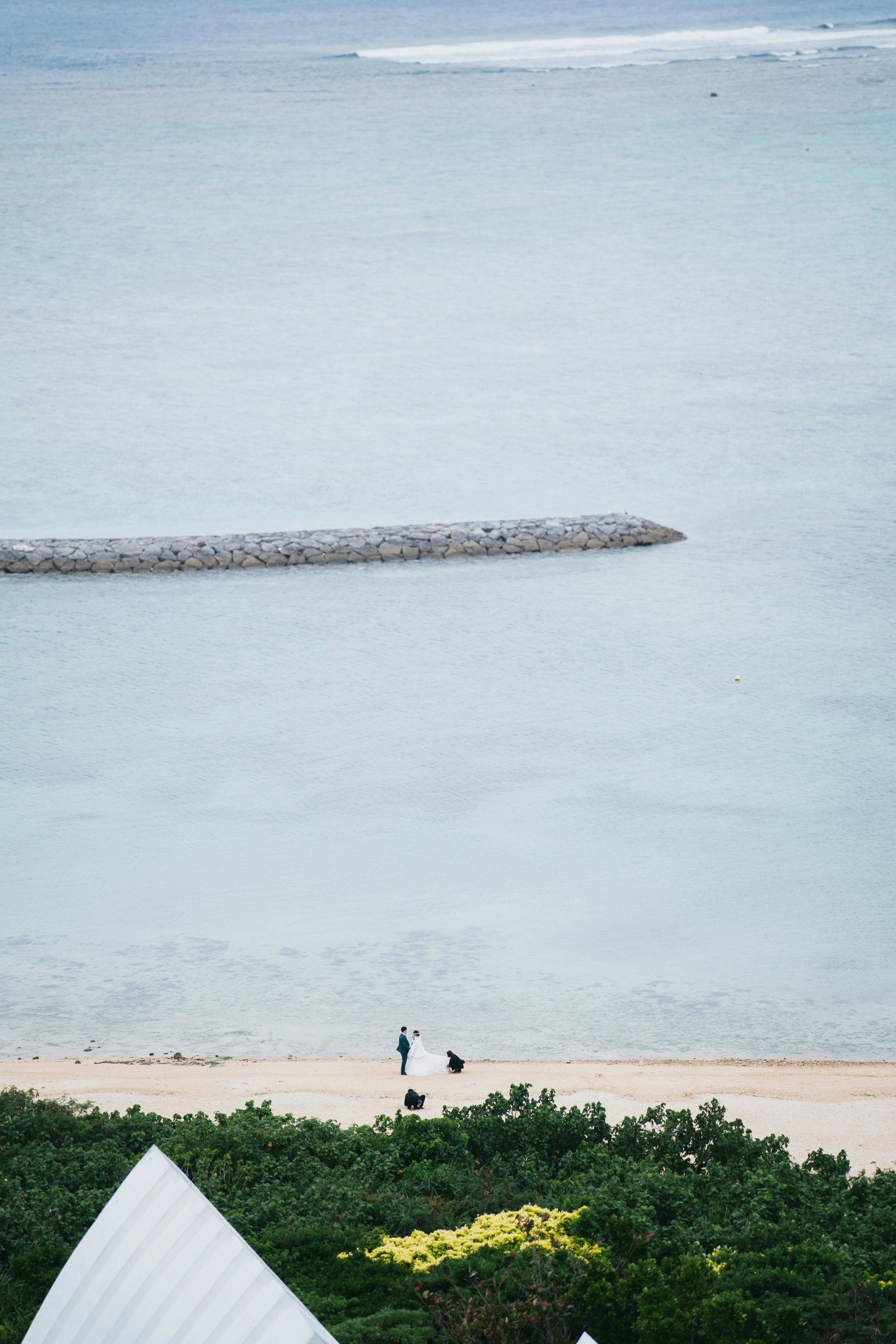 青い海とビーチに人々が歩いている風景