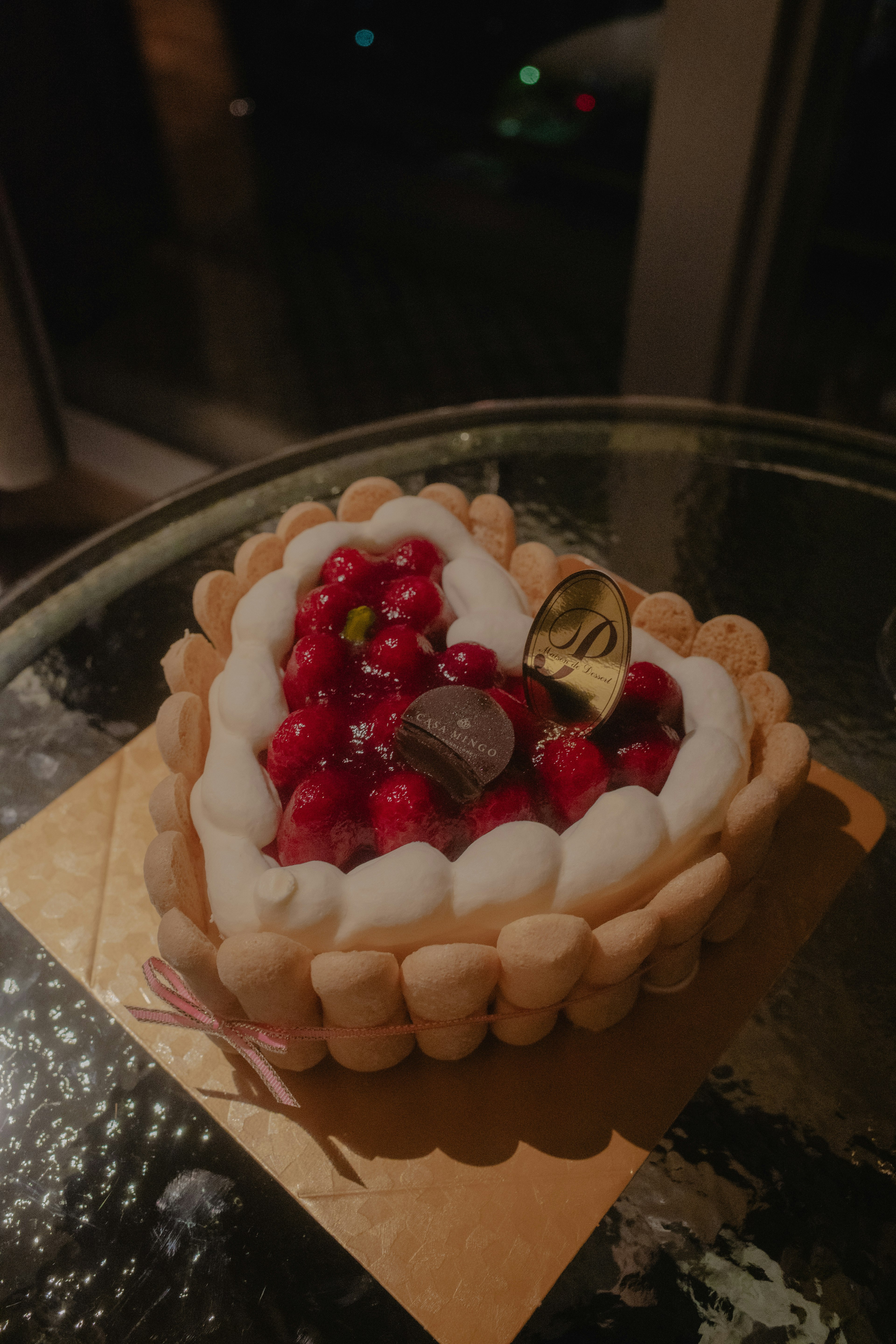 Heart-shaped cake topped with fruits and cream