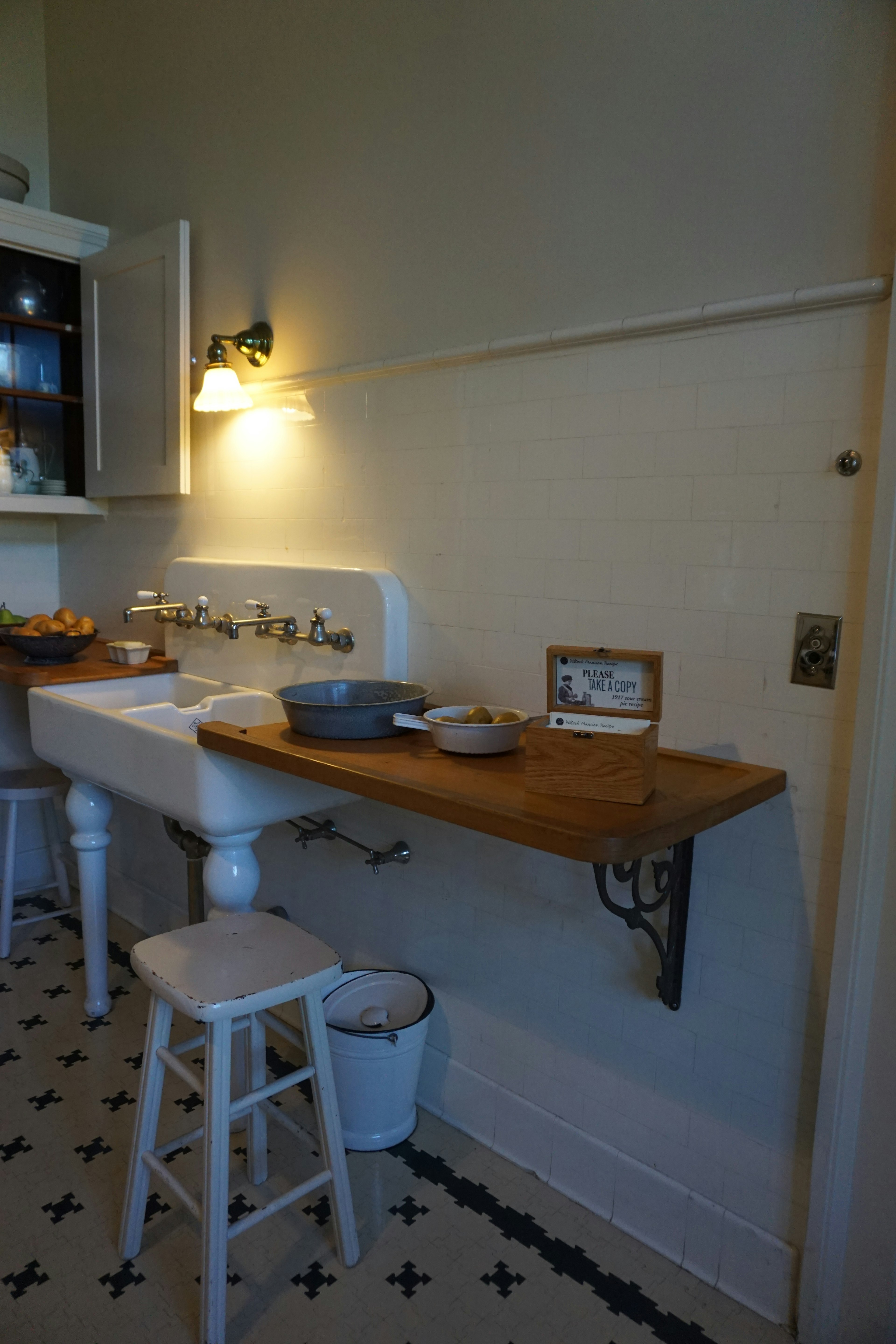 A simple kitchen space featuring a sink and wooden countertop