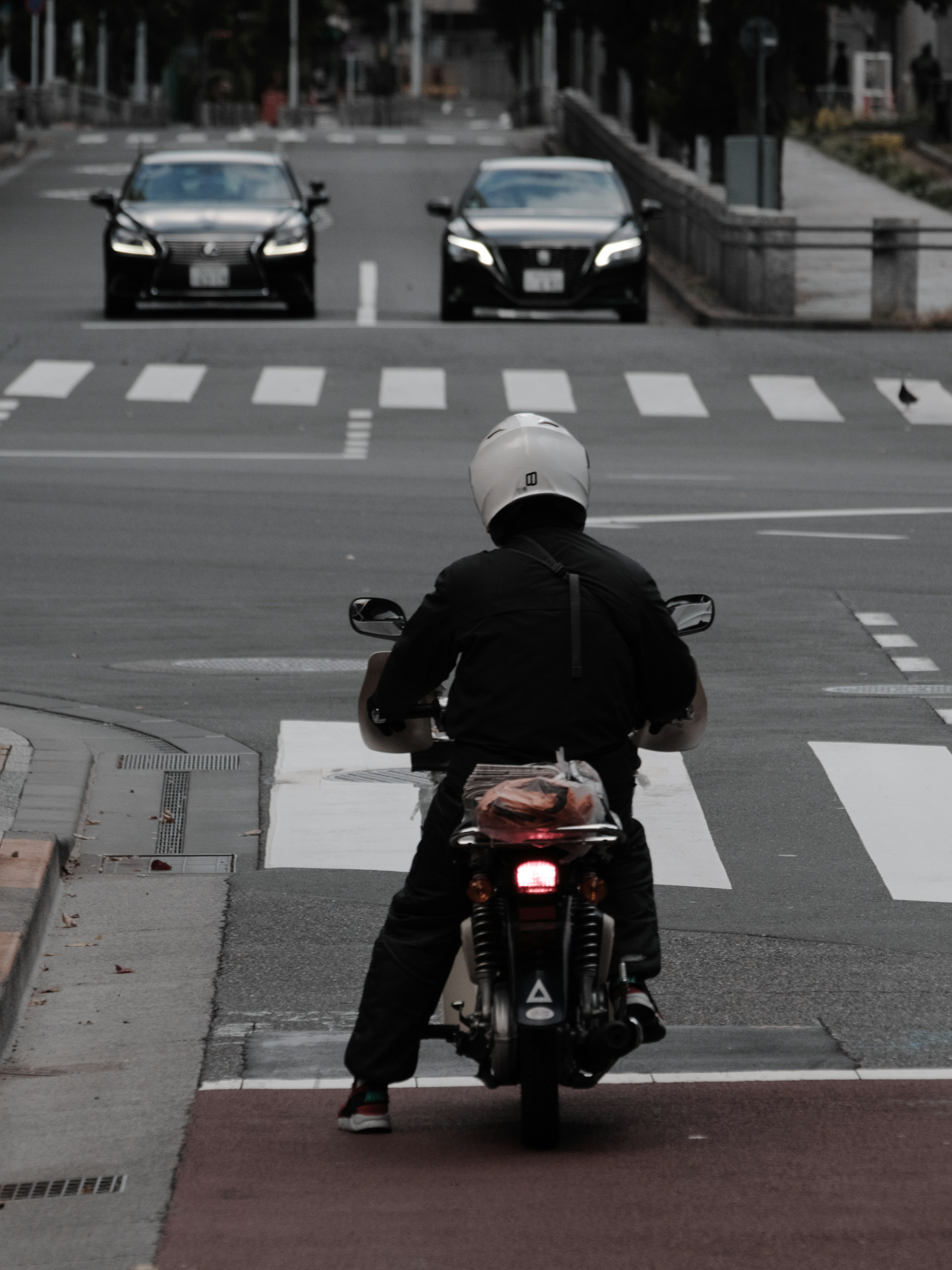 A person on a motorcycle waiting at an intersection