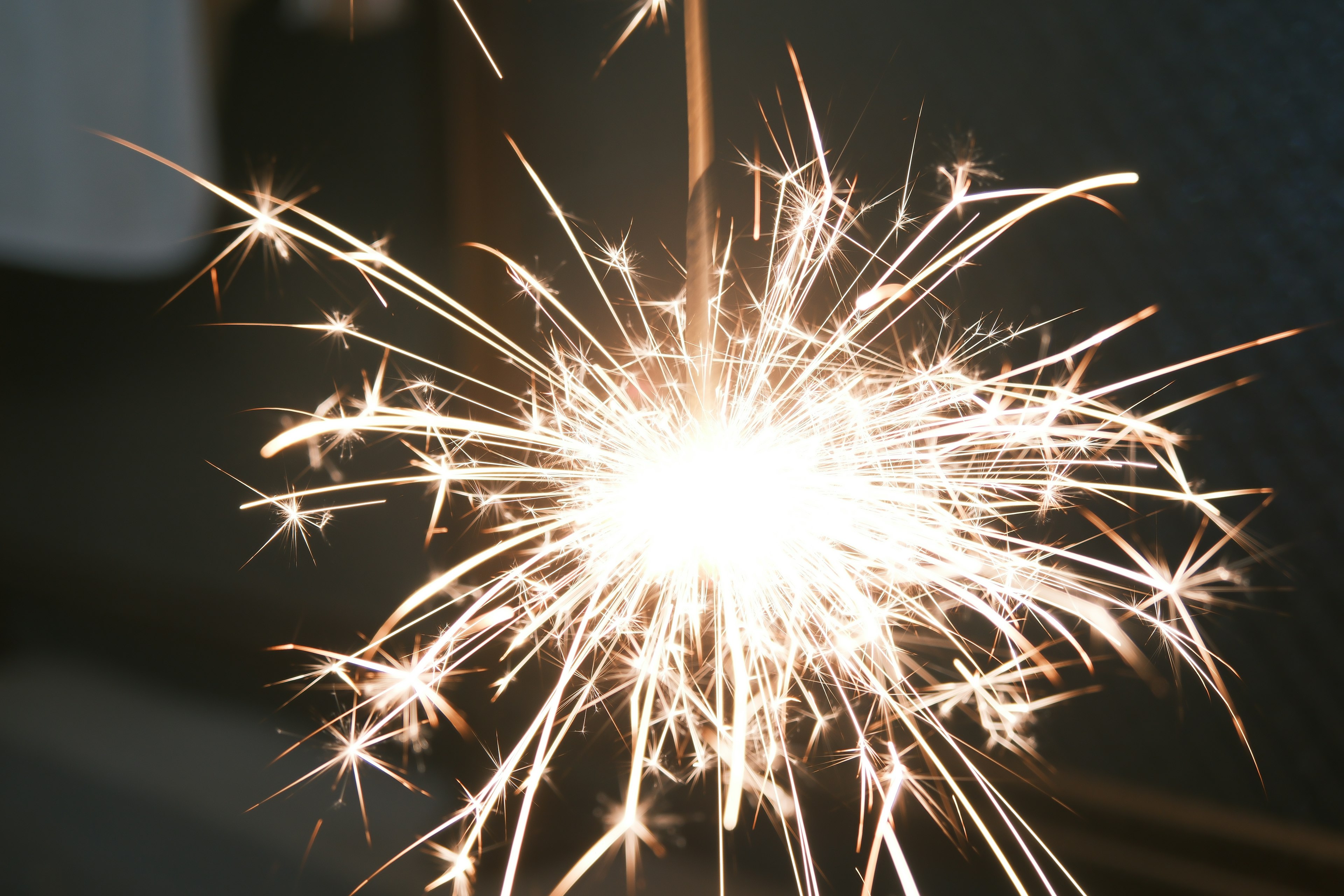 Close-up of a sparkling sparkler emitting bright light and sparks