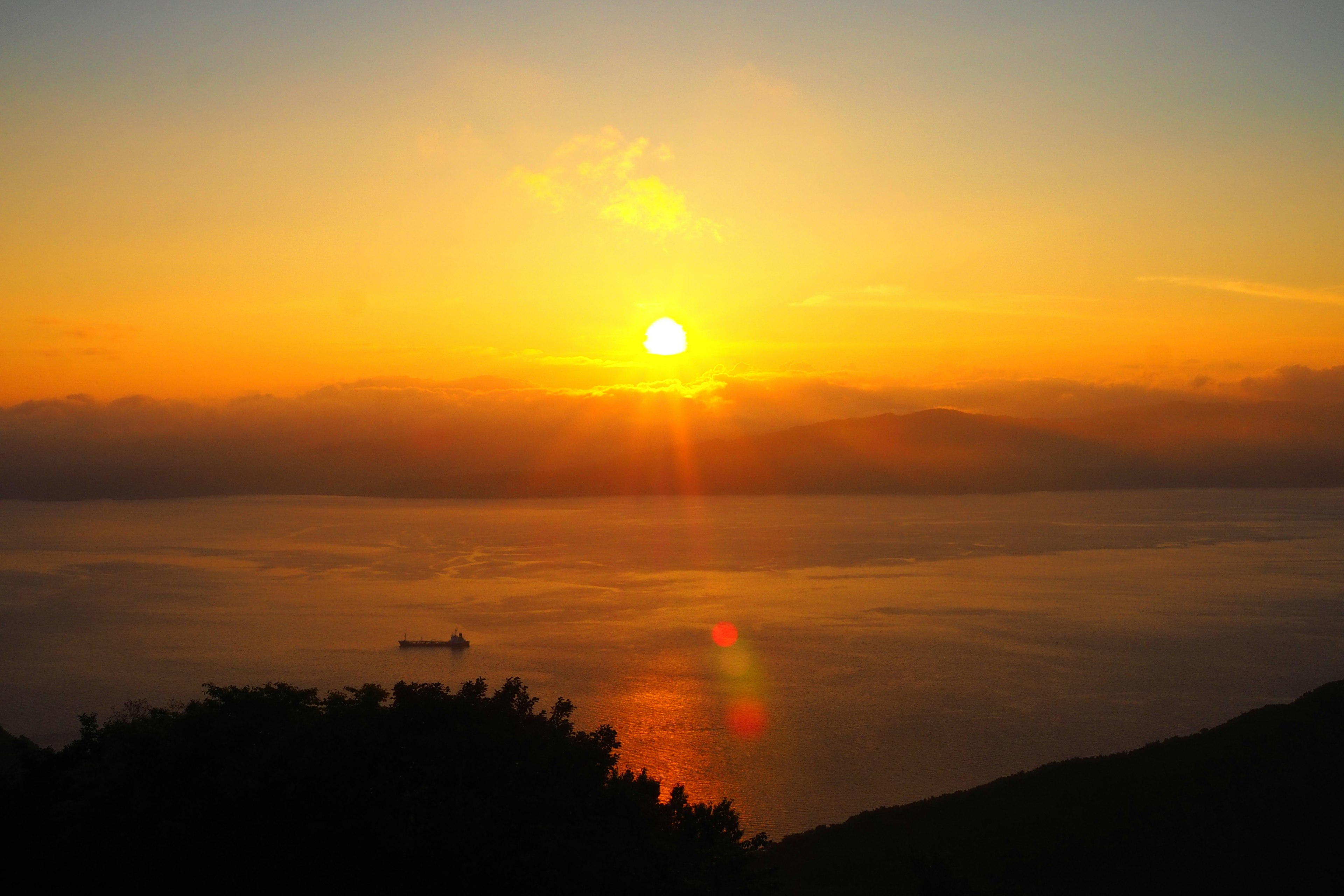 Beautiful sunset over the ocean with calm water reflections