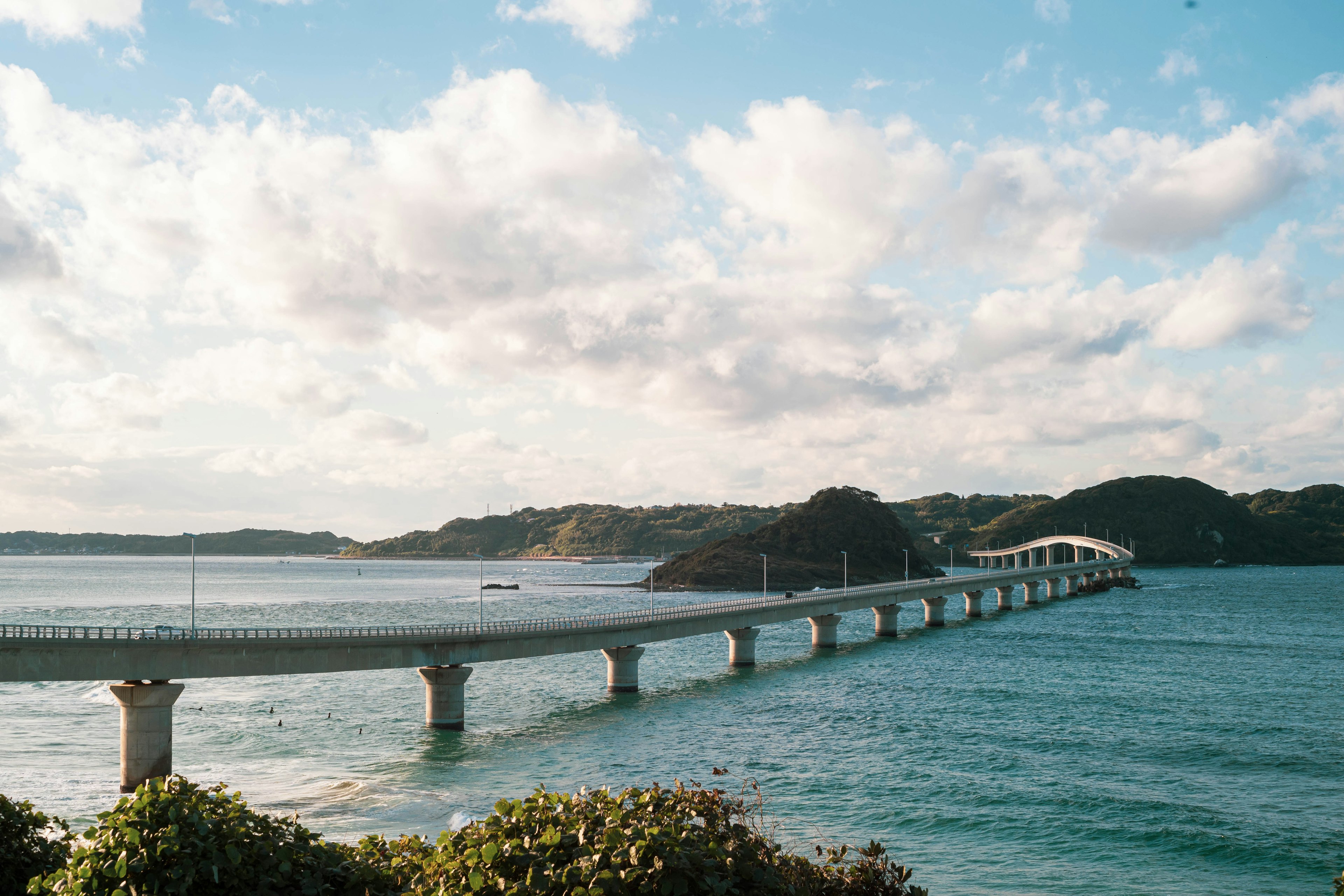 Long bridge over blue sea under a bright sky