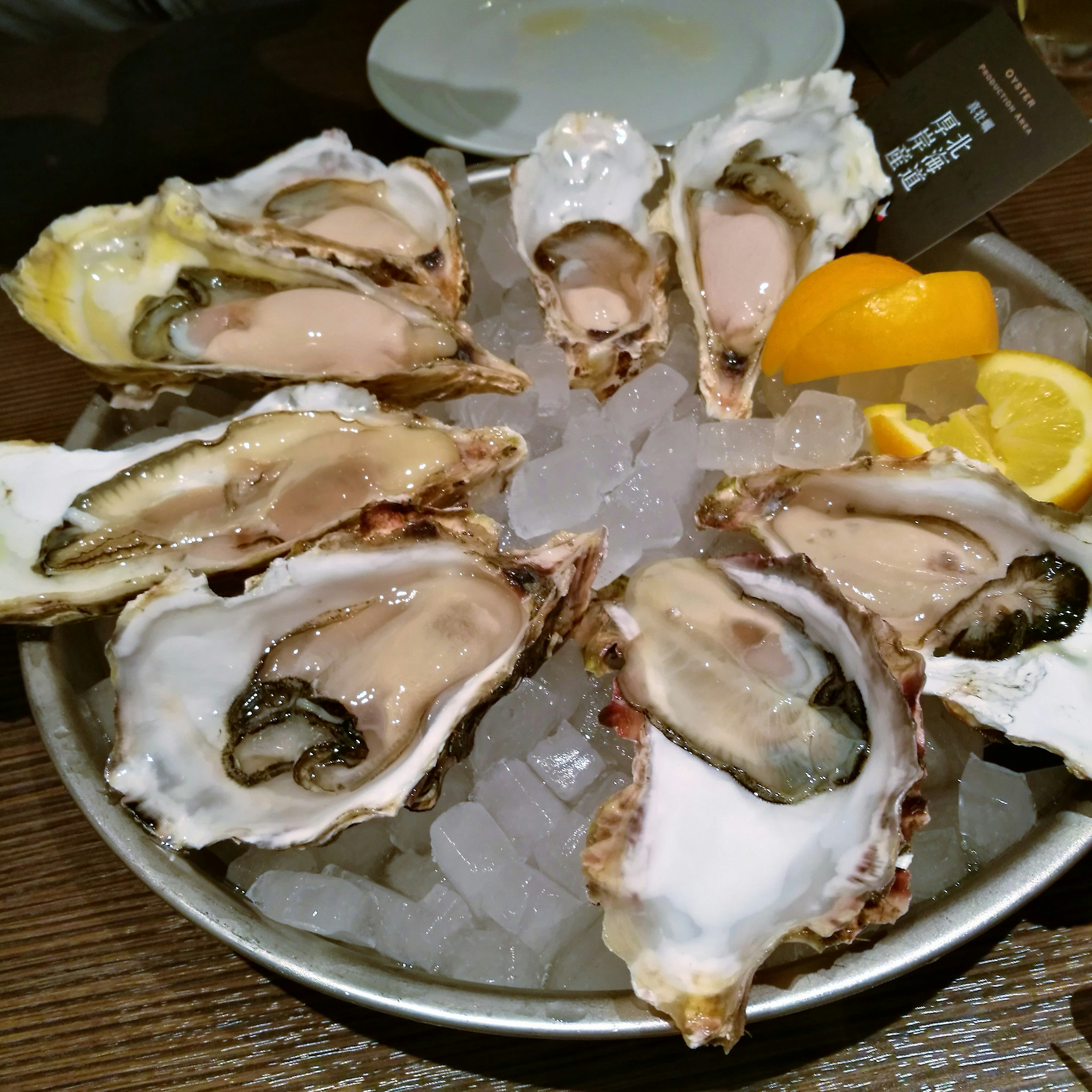 Fresh oysters arranged on ice with lemon slices