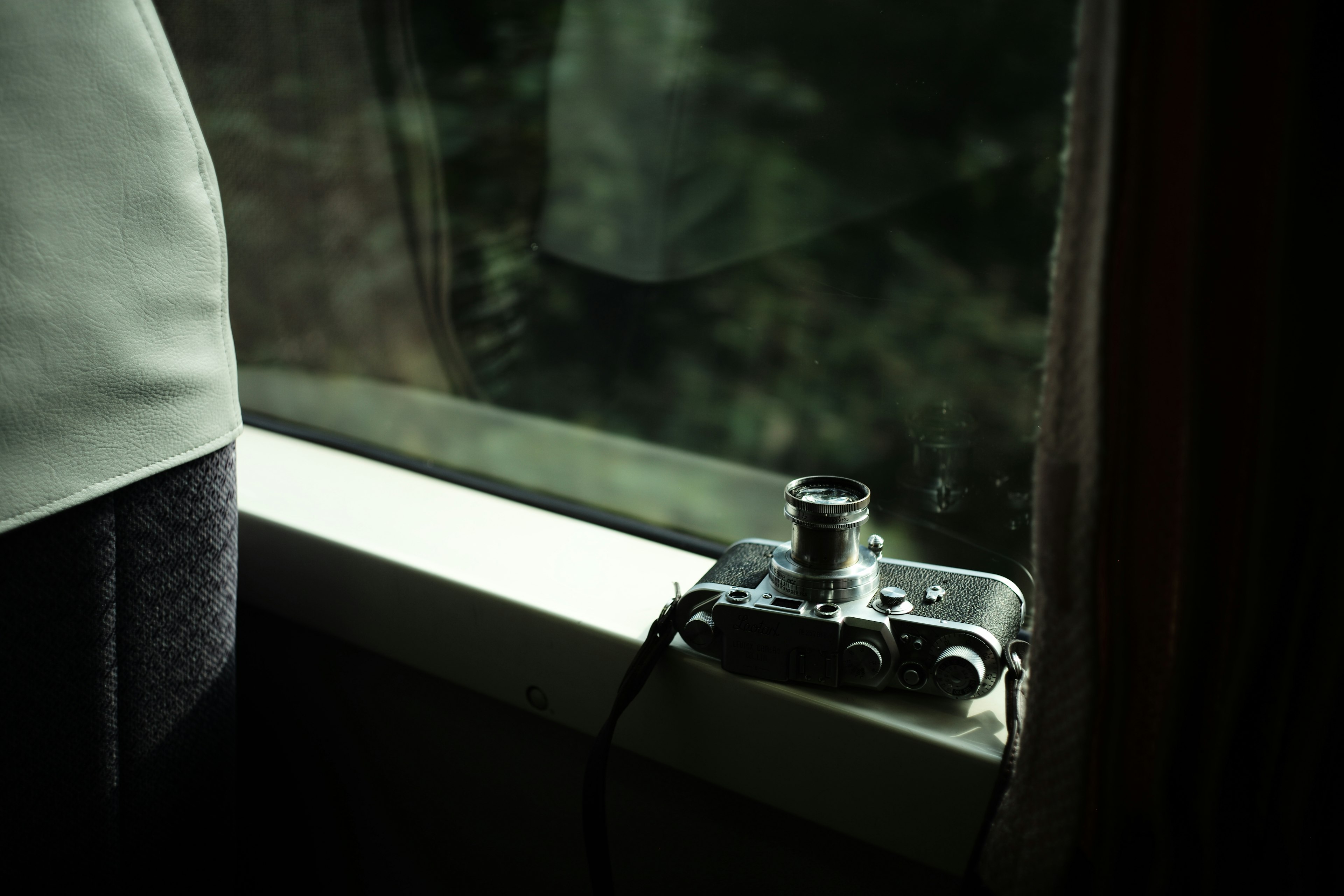 Camera resting on the windowsill beside a person