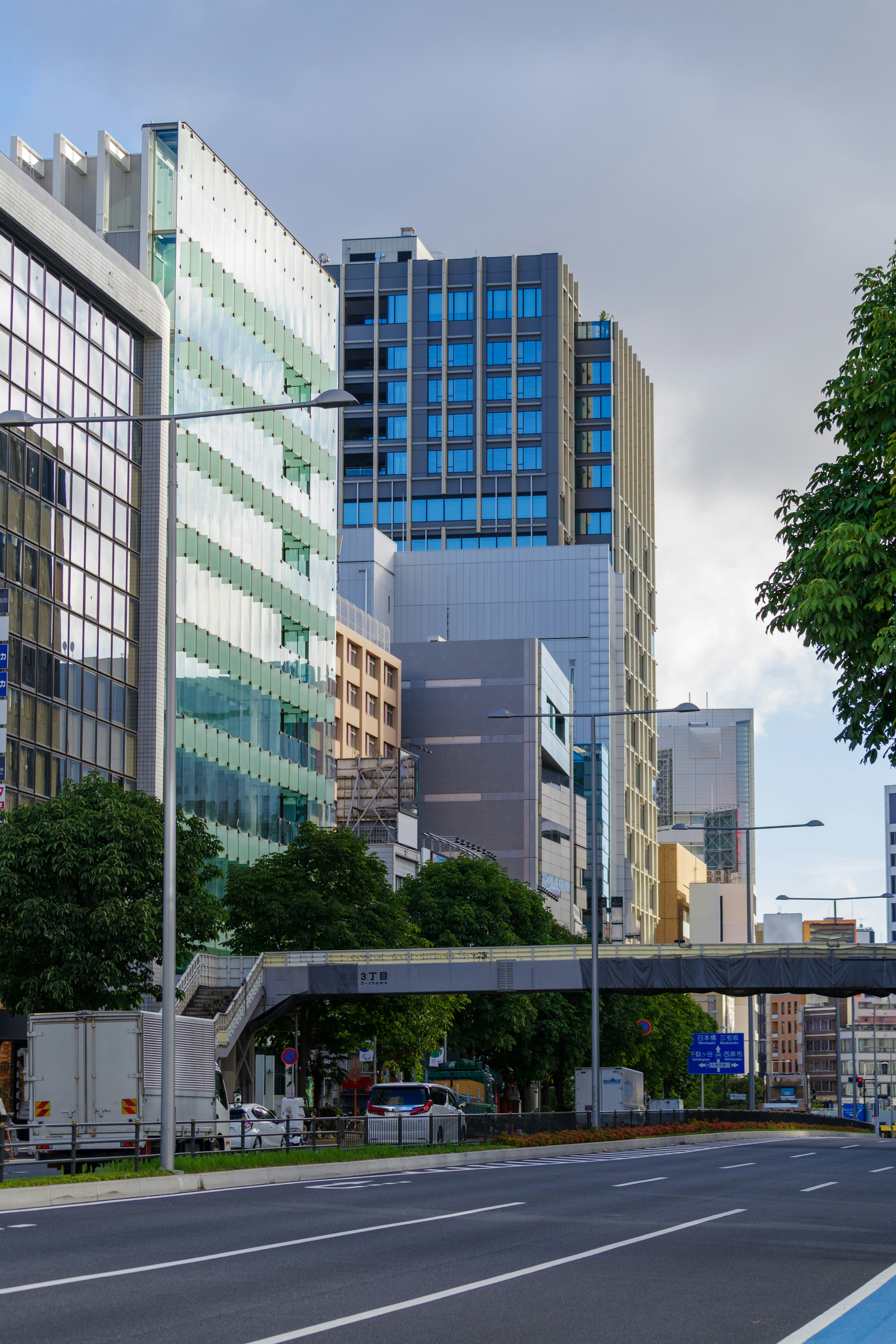 Urban landscape featuring modern buildings and pedestrian overpass