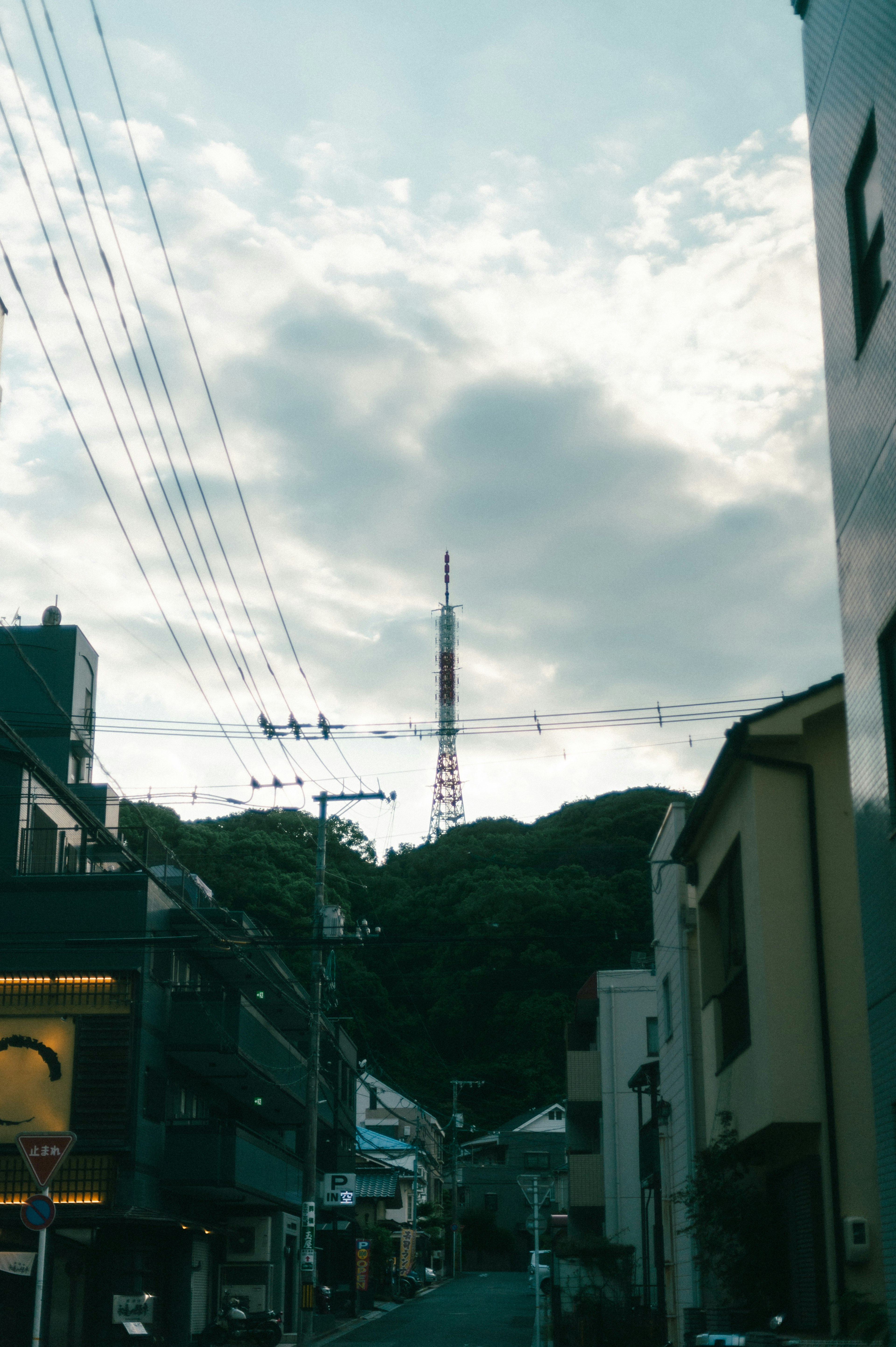 Urban landscape with a tower visible behind the hills