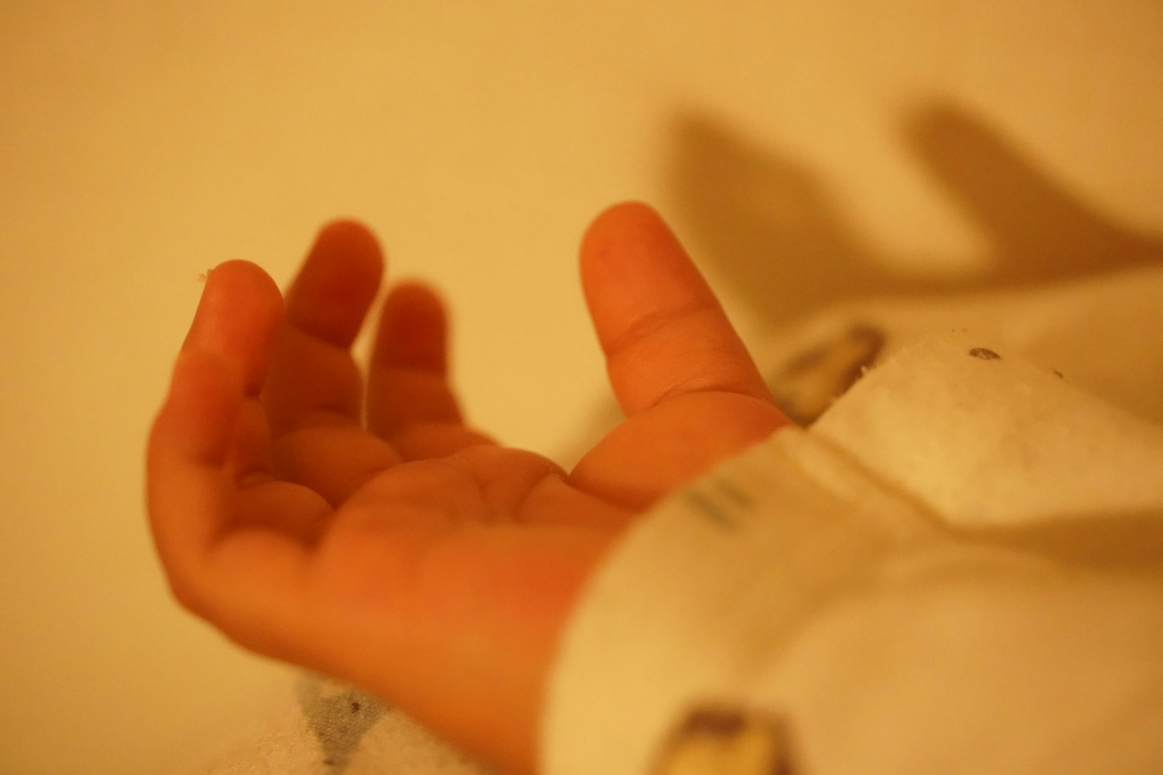 A soft palm resting on a white fabric surface