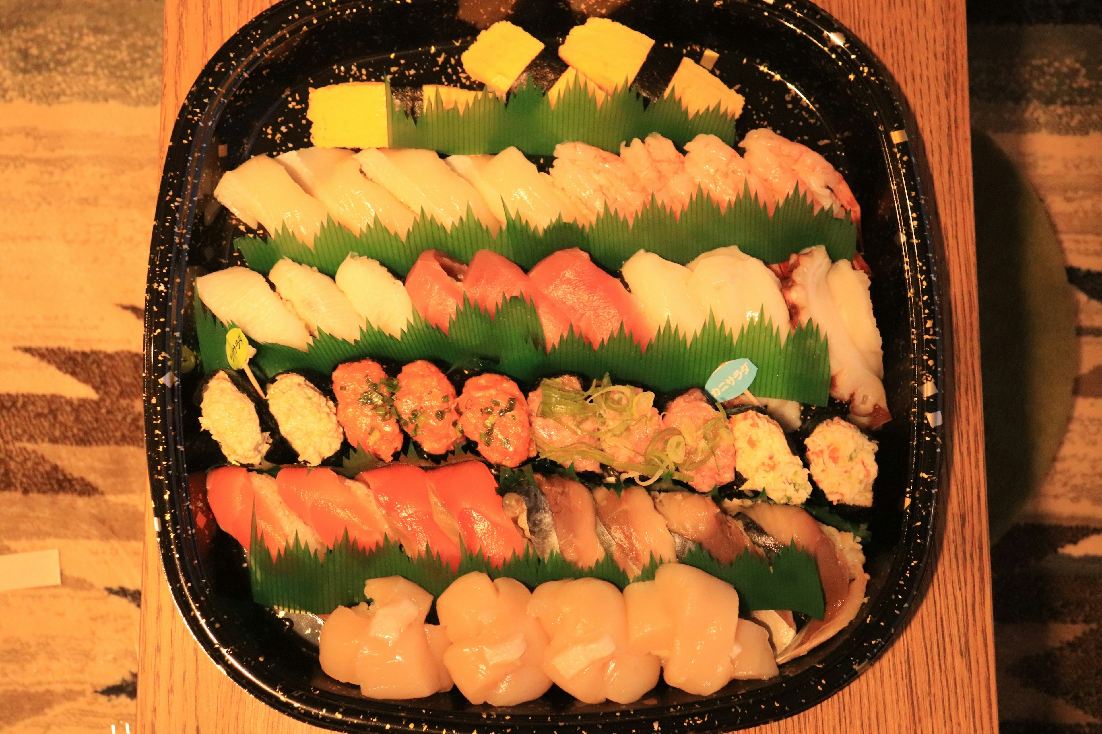 A colorful sushi platter with various types of sushi and garnishes