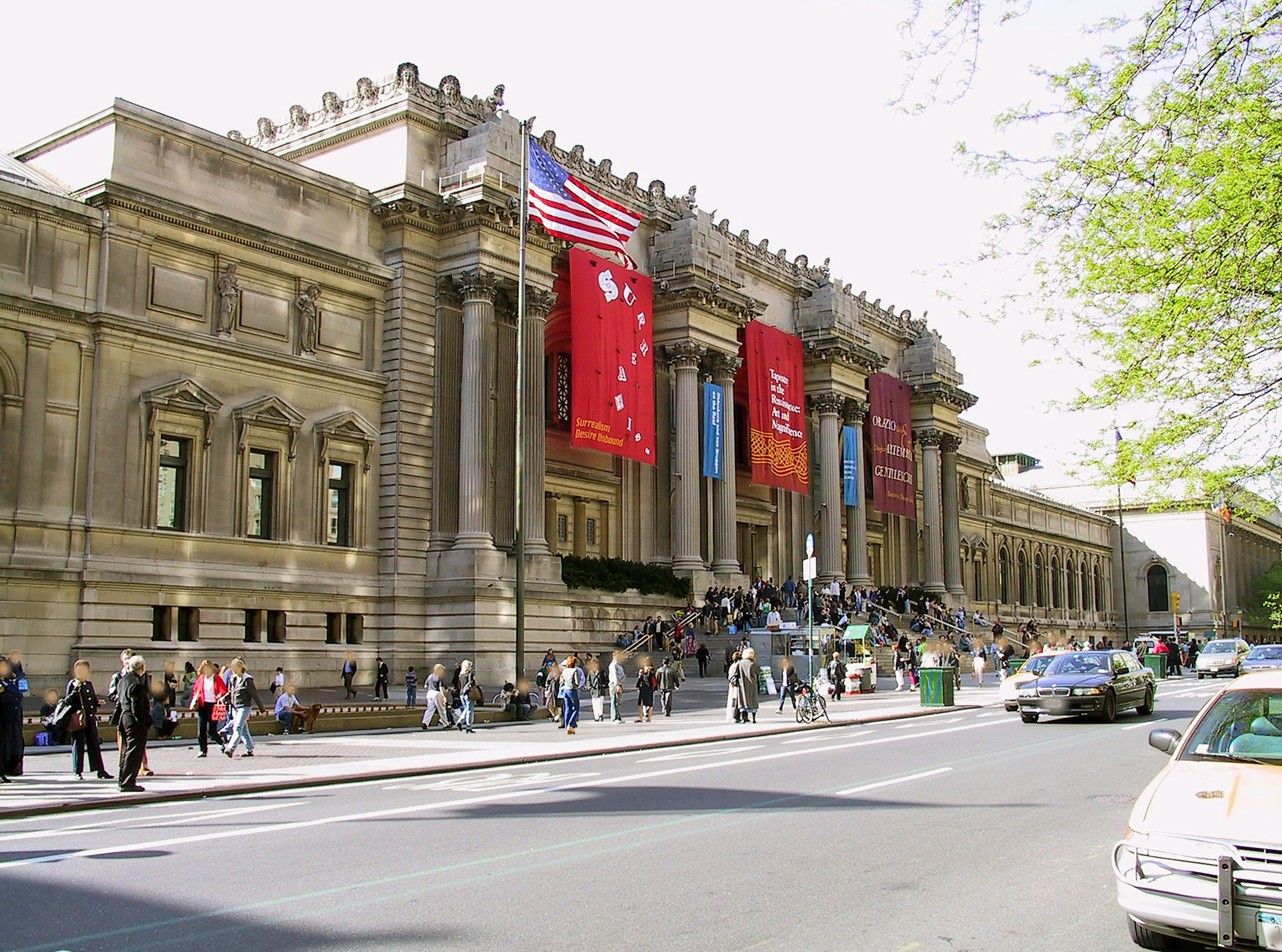 Eksterior museum seni dengan bendera Amerika dan pengunjung berkumpul