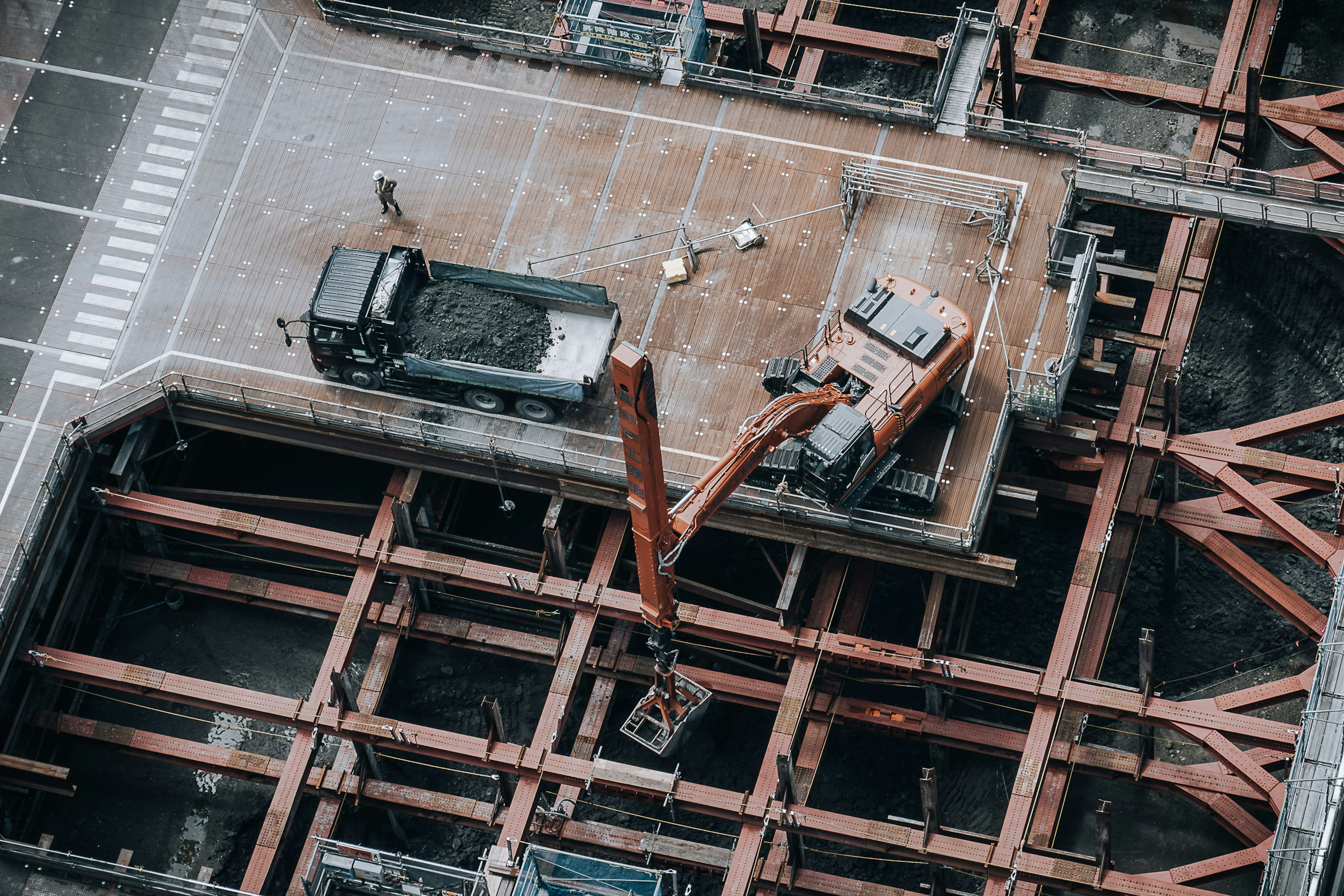 Aerial view of a construction site showing machinery and steel framework